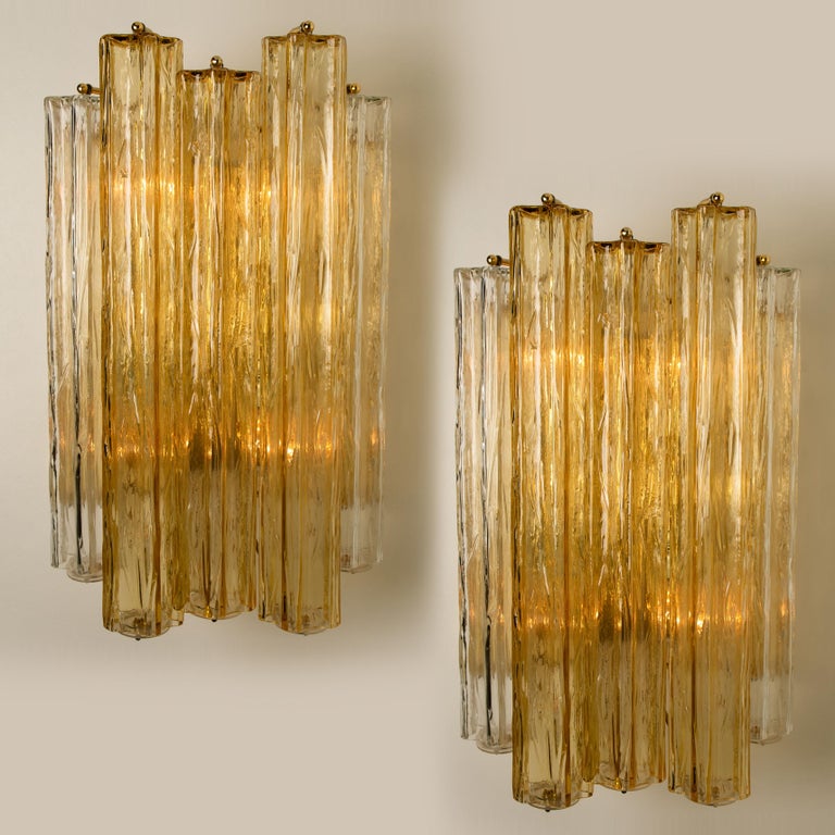 Wonderful extra-large mid century Barovier & Toso wall sconces. This wall sconces are executed to a very high standard. The lights feature a frame with 7 large Murano tubes in ocher(5) and clear(2) star formed glass. The tubes diffuse the light