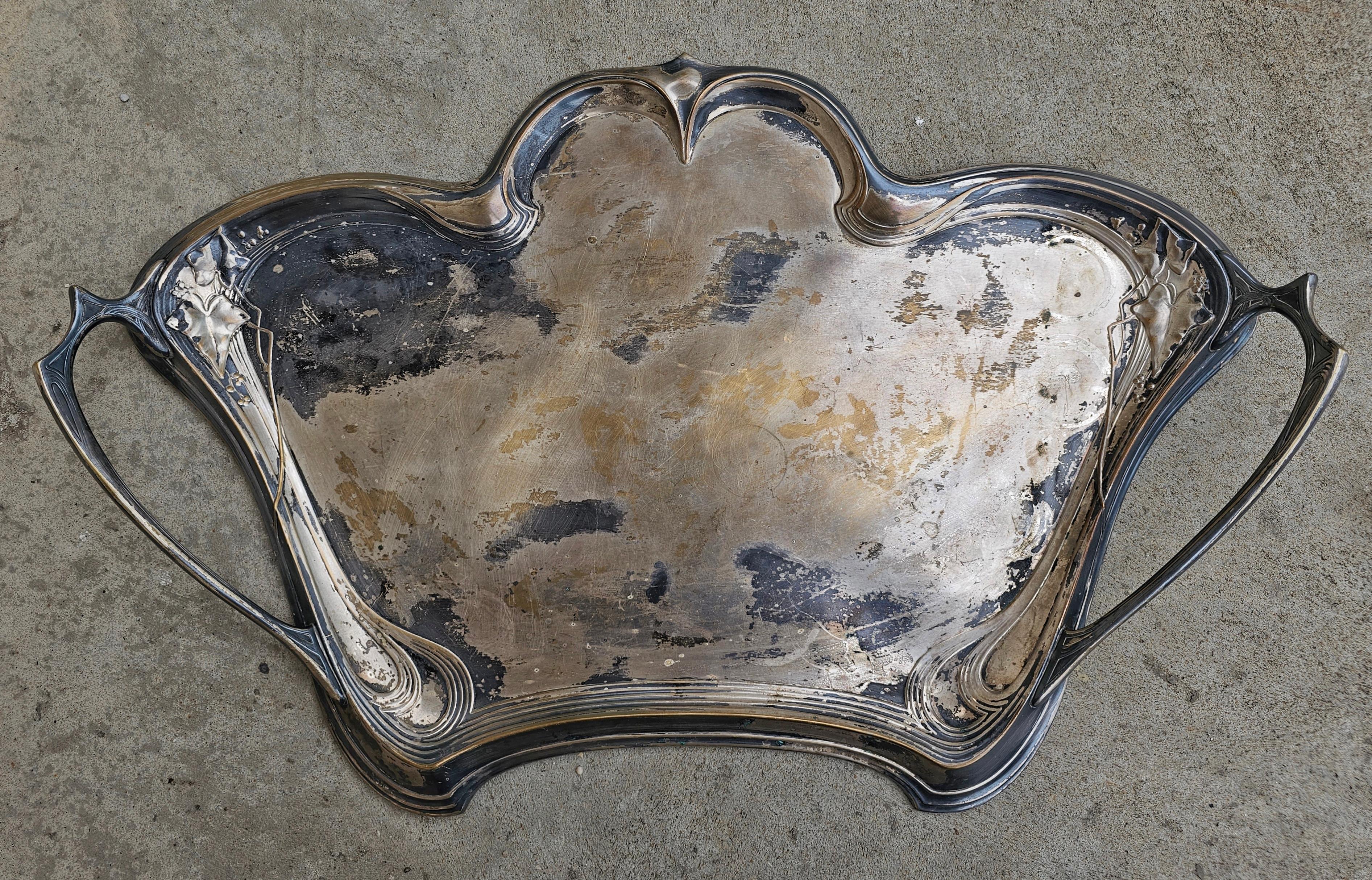 In this listing you will find an extremally rare German WMF Art Nouveau silver plated handled waiter's tray with berry and ivy foliage relief with Art Nouveau patterns and decorative handles. This beautiful tray fits neatly into the waist of the