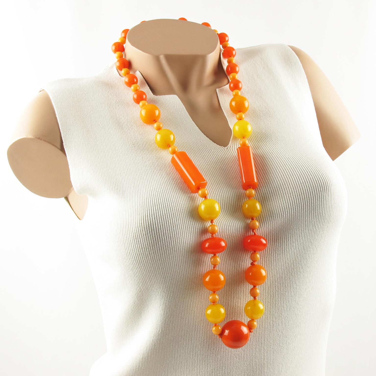 Lovely extra long Bakelite necklace. Assorted beads in various carved shape: round, tomato, long stick and large central bead. Lovely mix and match of colorful sunny colors in assorted tones of neon orange marble, orange tangerine marble, milky