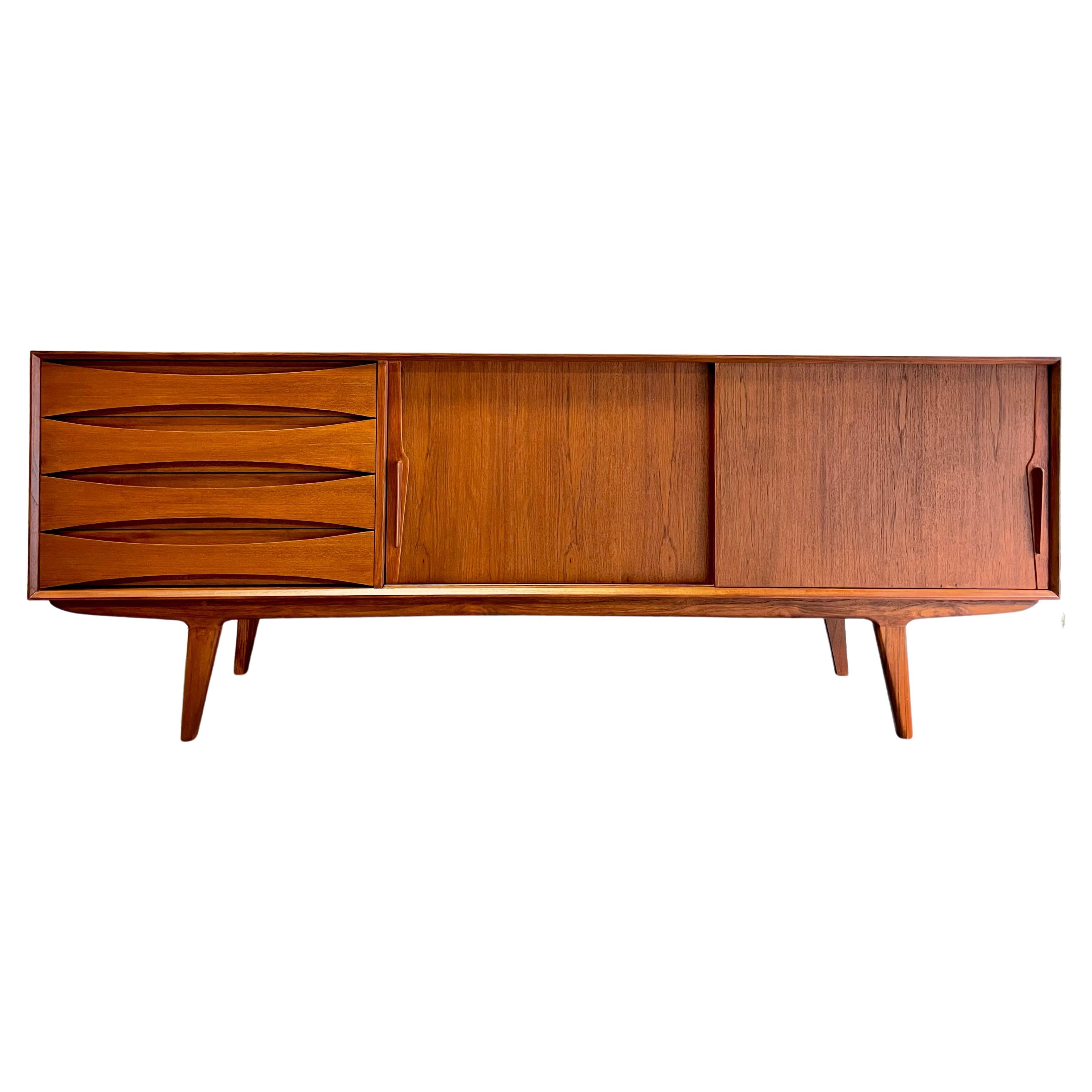 Extra long Mid Century Modern styled handcrafted Credenza / Media Stand. This beauty features exquisite knife-edge hand pulls and sculpted drawer fronts with slightly splayed legs. Stunning wood grains and finished back allow you to float the