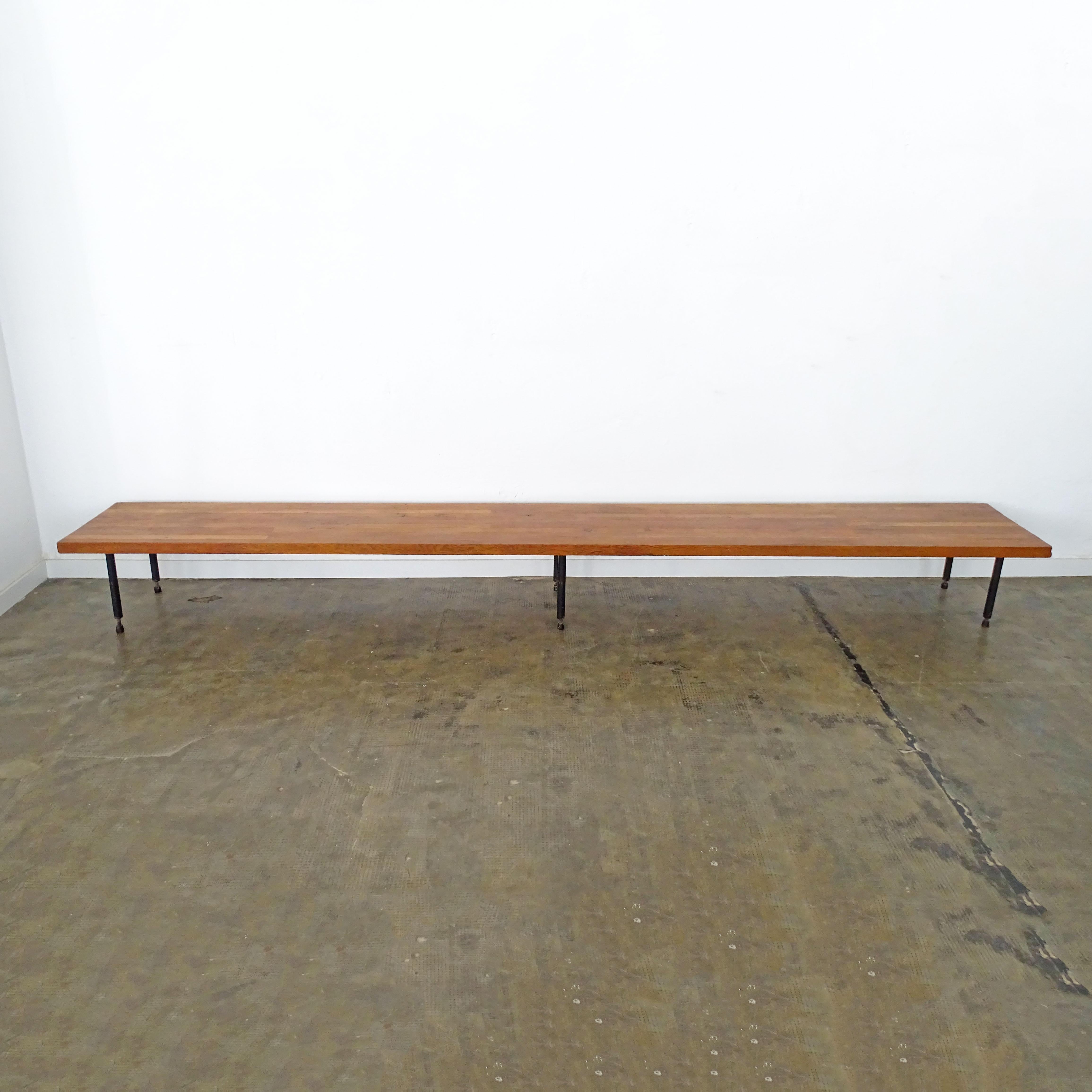 Extra long Italian 1950s wooden bench on black lacquered metal legs.