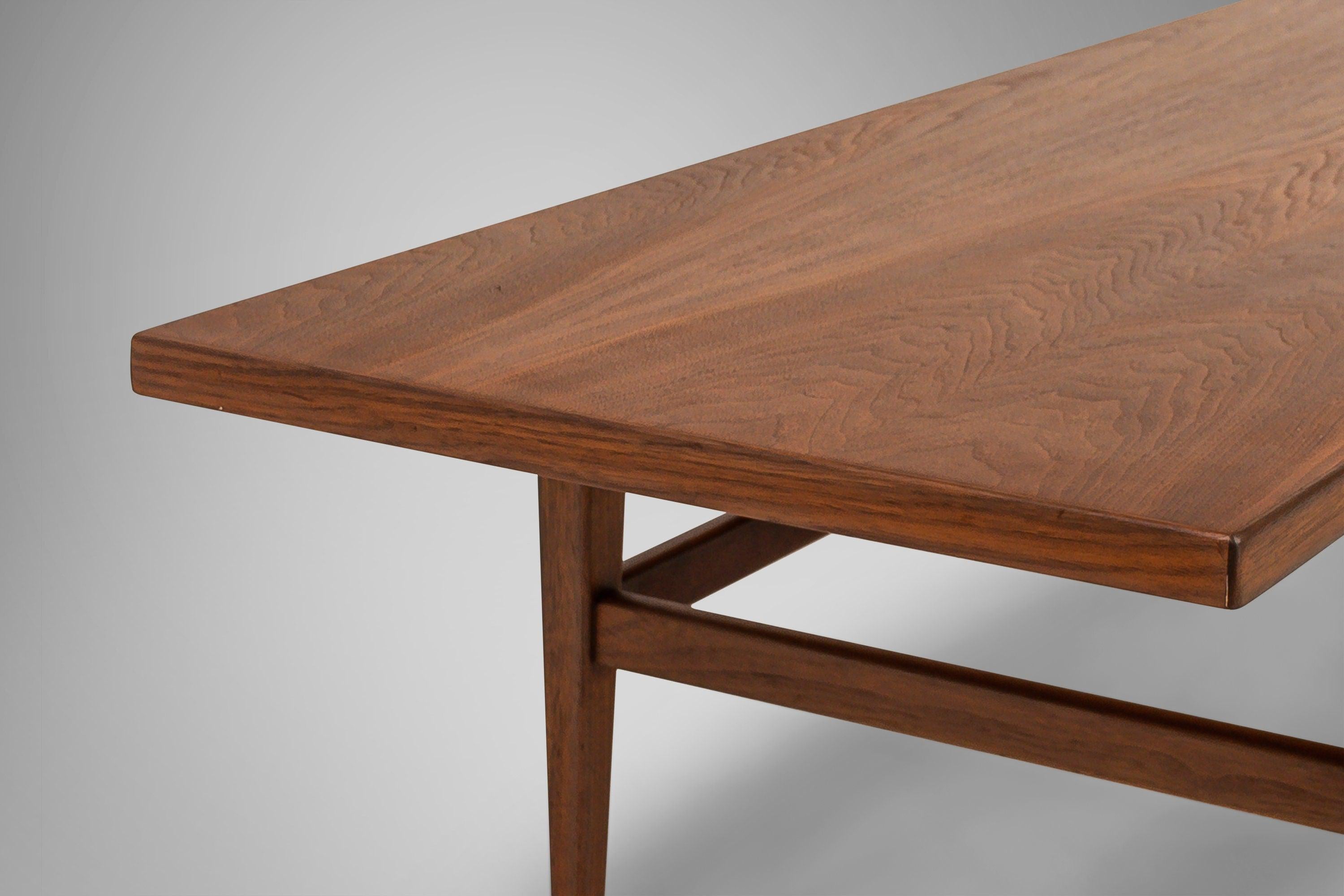 Constructed from walnut. Extra long coffee table set on tapered legs. Simple and yet stately. Circa 1960s.
   
