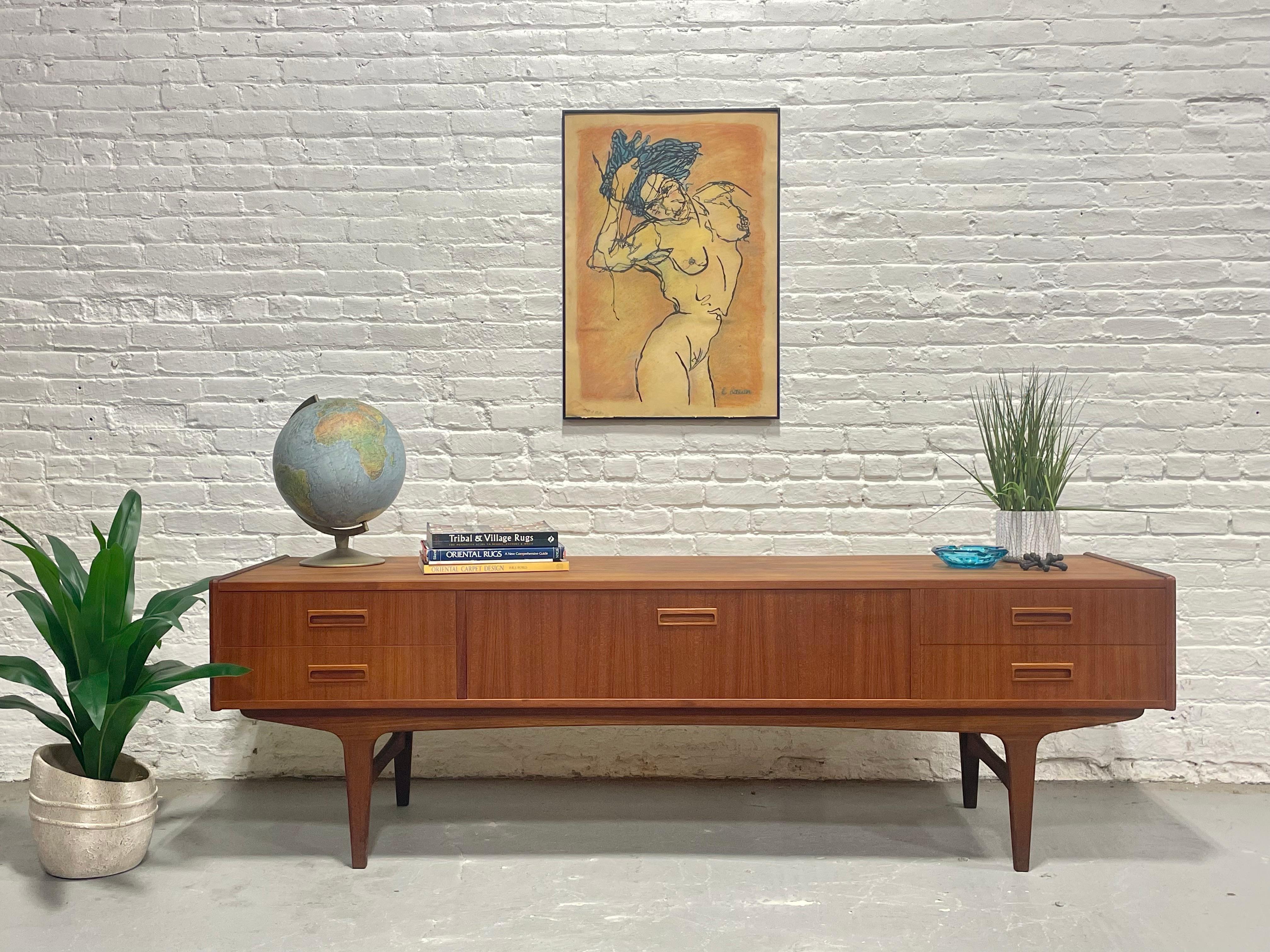 Long and low, this Mid Century Modern credenza by P. Westergaard’s Møbelfabrik, c. 1960s, is a rare Danish design gem. Crafted in richly grained teak wood, it features a hard-to-find extra low height, making it perfect beneath a TV or as a sleek