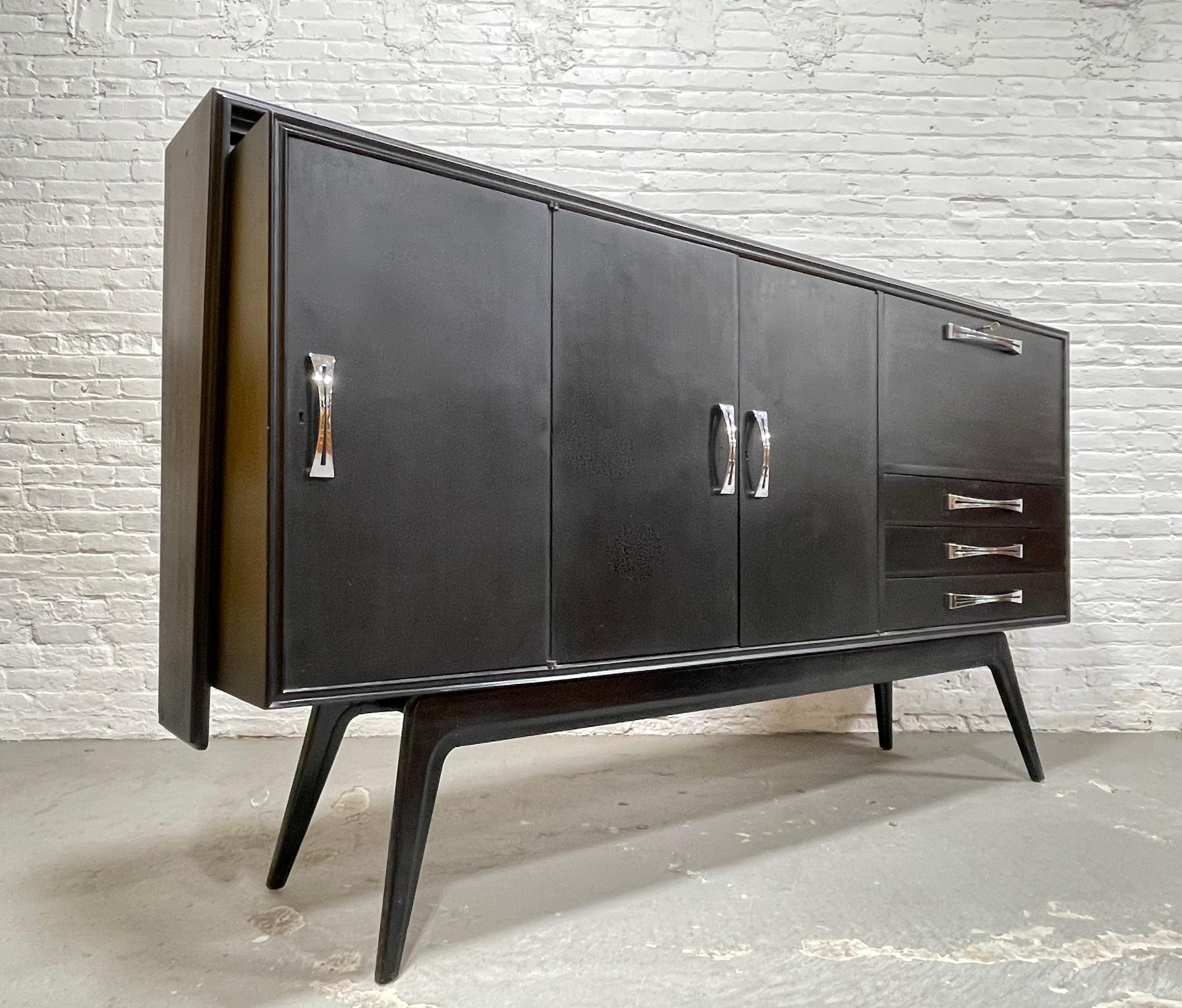 Extra Long Italian Mid Century Modern Ebonized Highboard Credenza / Sideboard / Bar, c. 1960's. This imposing piece is beautifully ebonized in matte black with beech interior and will easily be the highlight of any room.  This beauty offers a wealth