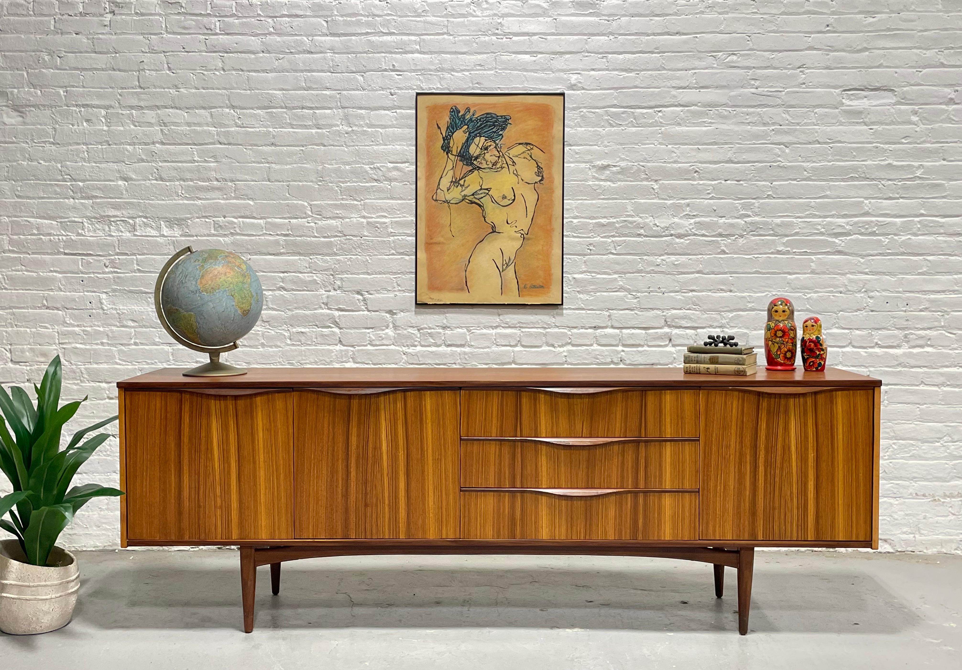Rare Mid Century Modern Credenza / Media Stand designed by Tom Robertson and manufactured by A.H. McIntosh, Scotland, c. 1960's. Simple yet extremely functional design and the perfect layout for a media stand - generous shelving for components