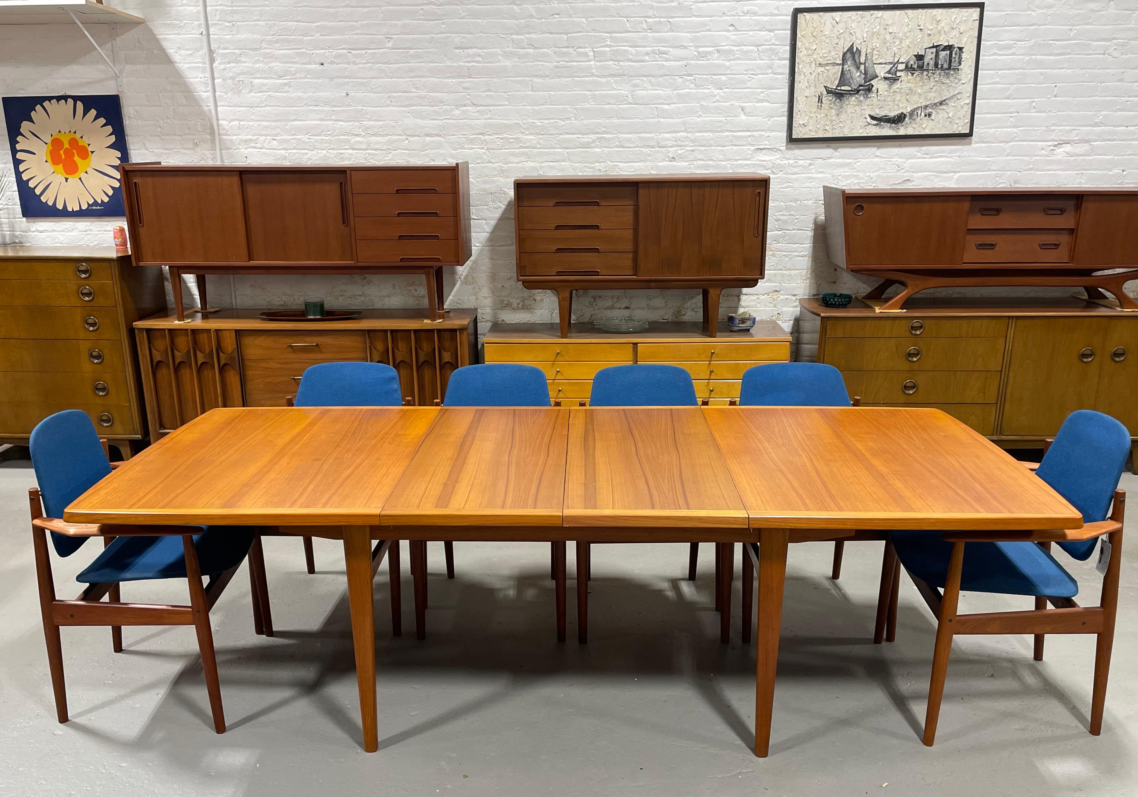 An exceptional Extra Long Mid Century Modern Expandable Teak dining table, circa 1960’s. This incredible table has beautiful wood grains and expands from 65” to either 83.5