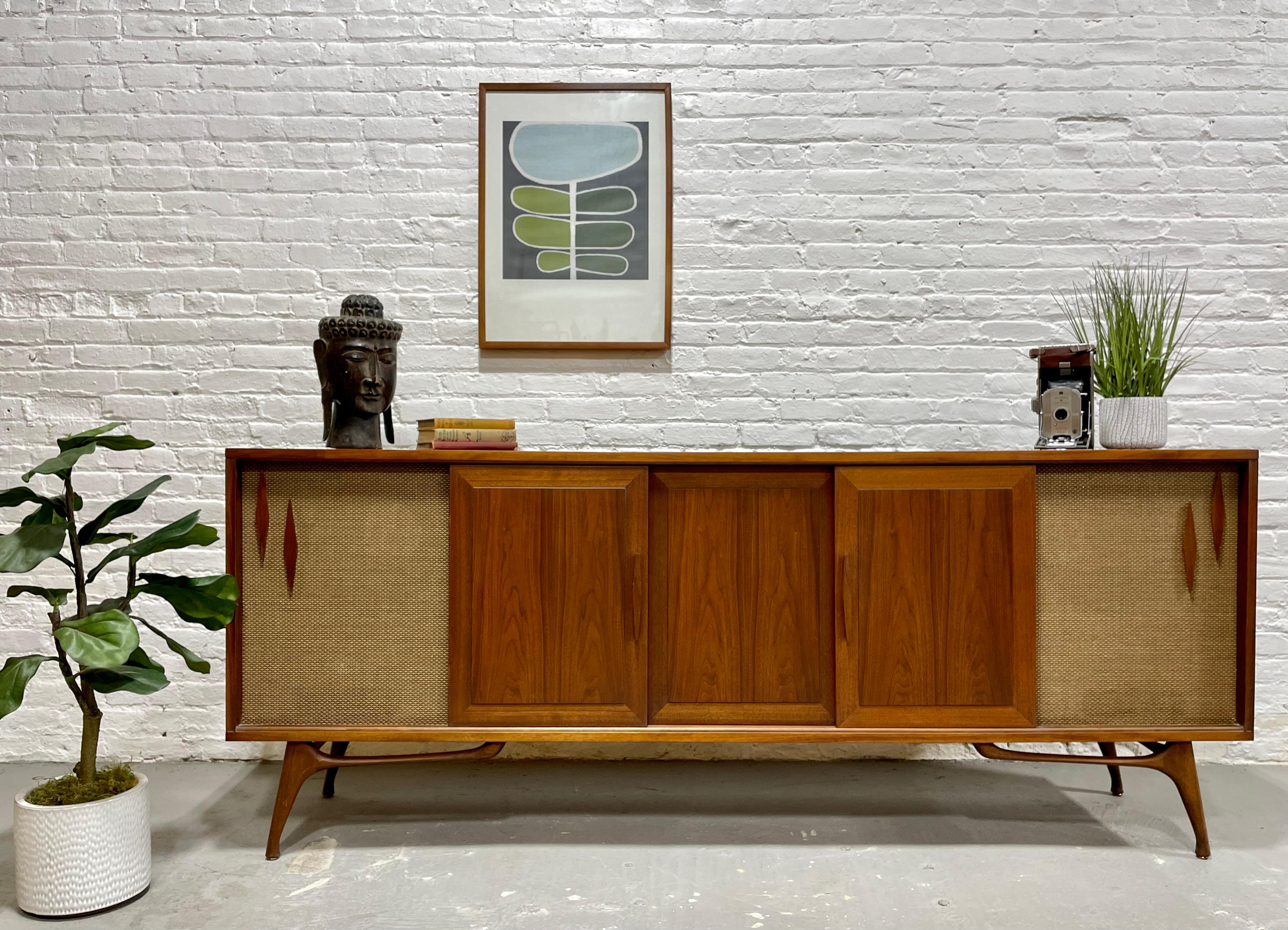 Extra Long and superbly incredible Mid Century Modern Stereo Cabinet / Credenza, c. 1960's. This custom made walnut sideboard is truly one of a kind and will fill your wall like no other. The credenza is flanked by two speaker storage cabinets on
