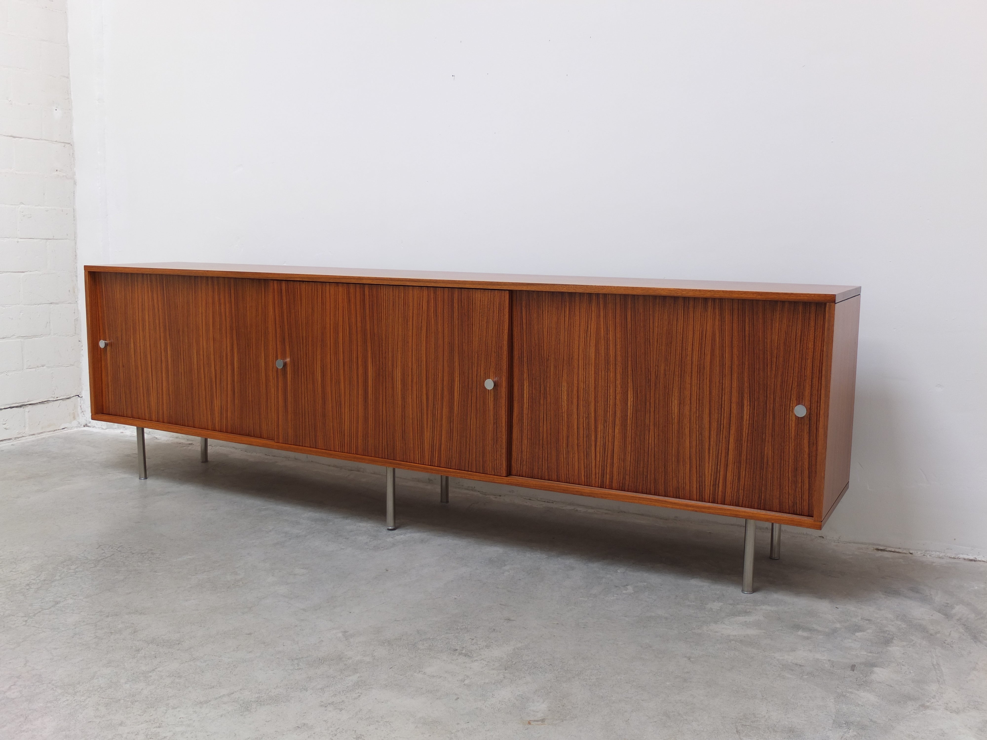 Large minimalist sideboard designed by Alfred Hendrickx for Belform around 1960. This is a rare extra long version of 280cm wide with three sliding doors instead of two. Pretty uncommon but it was available to order as seen in the Belform catalog.