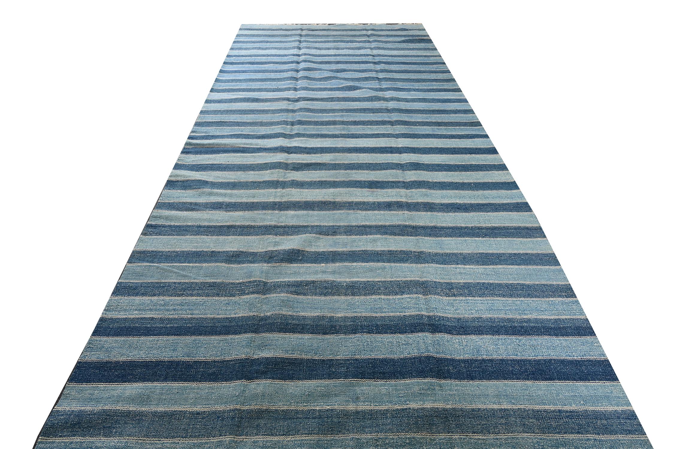 This vintage 6x23 Dhurrie is an exciting new entry in Rug & Kilim's esteemed flat weave collection. Handwoven in cotton, it originates from India circa 1950-1960. 

Further on the Design:

This flat weave prefers a simple series of stripes in