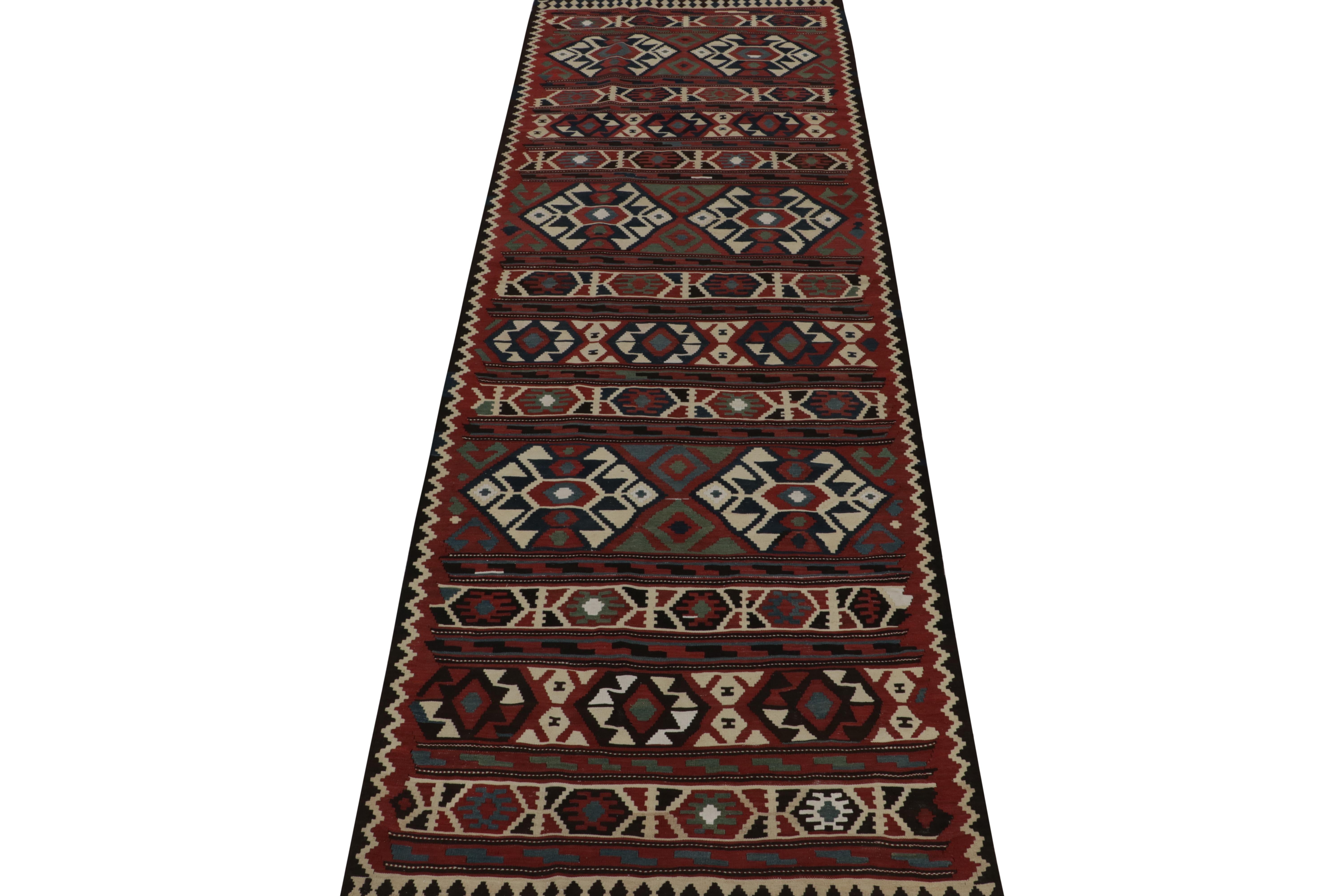 This vintage 5x15 Persian kilim is a rare, extra-long gallery rug—handwoven in wool circa 1950-1960.

Further on the Design:

A brick red background hosts traditional tribal motifs in navy blue, teal, and off-white colors that have kept up