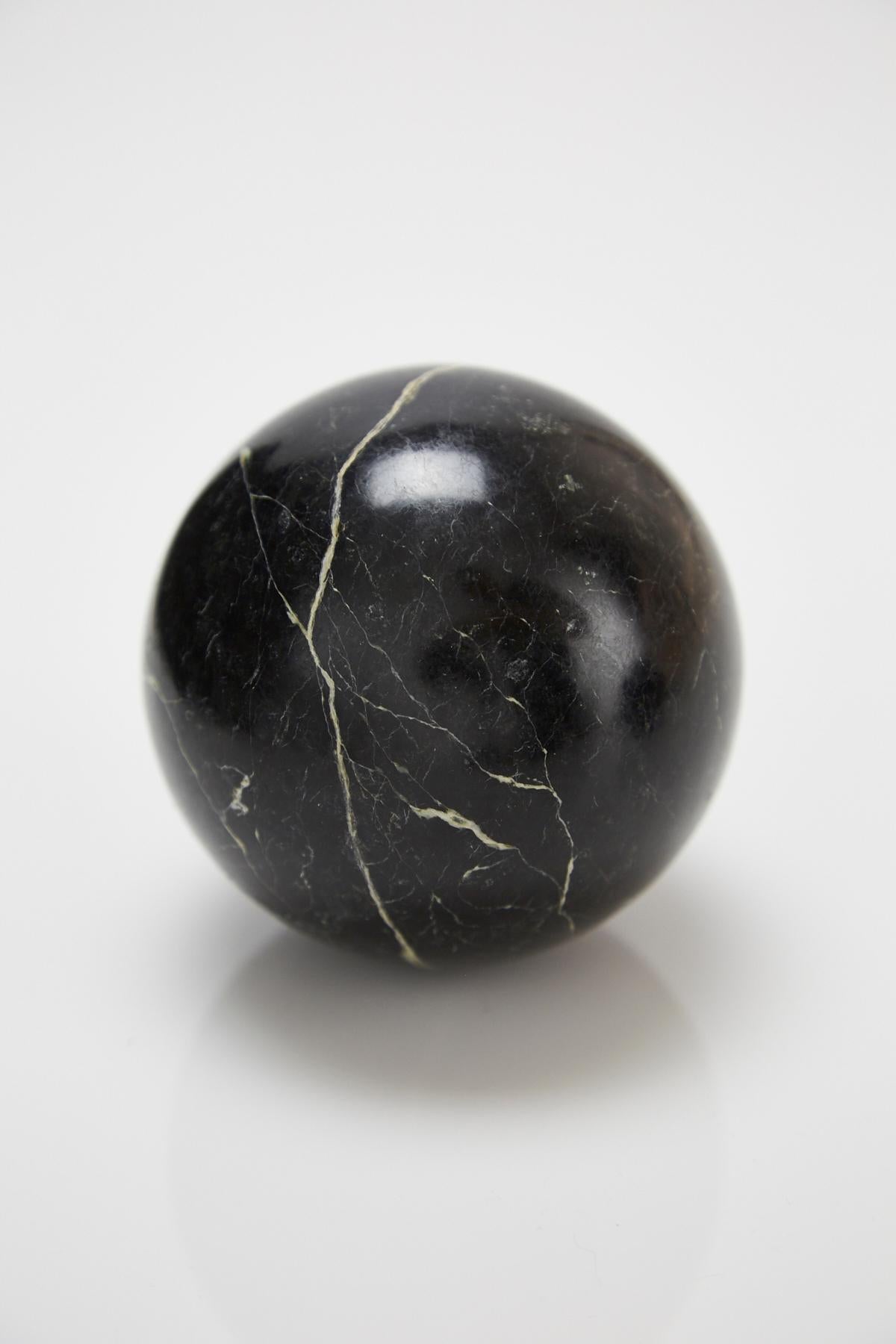 Extra small decorative sphere measuring 3.5 in. diameter. Solid black stone sphere with flattened end for balance.