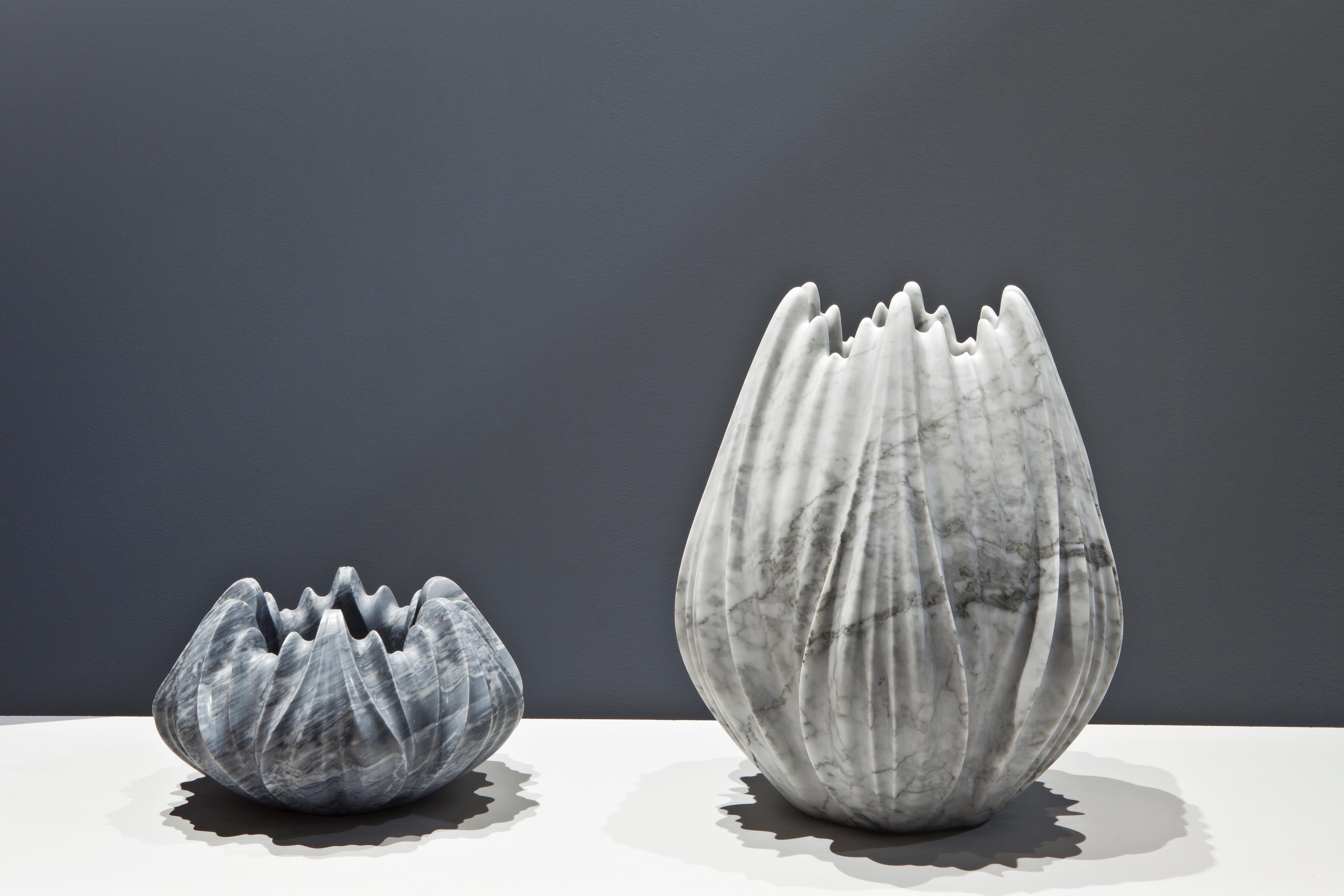 The Tau vases created by the iconic Zaha Hadid appear organic; emerging as a series of intricately rendered pleats expressing the formal complexity of natural growth systems. 

Seemingly as delicate as flower petals, the fragile aesthetic of the