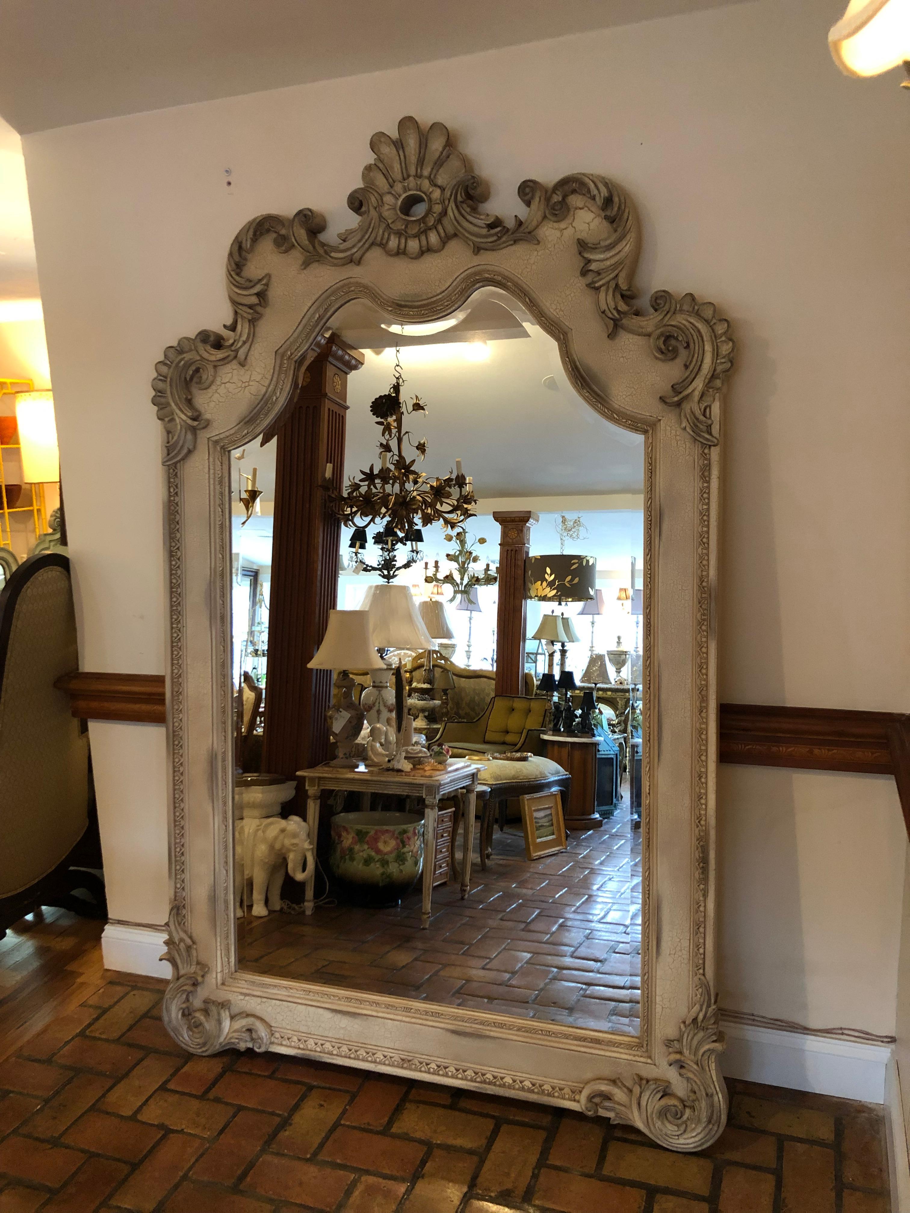 8 ft. Tall Hollywood Regency  leaning or wall mount mirror. Highly ornate with over an inch bevel this cream beauty will light up the room with its details. This mirror will help open up small rooms by reflecting light. Use in a dressing room or a