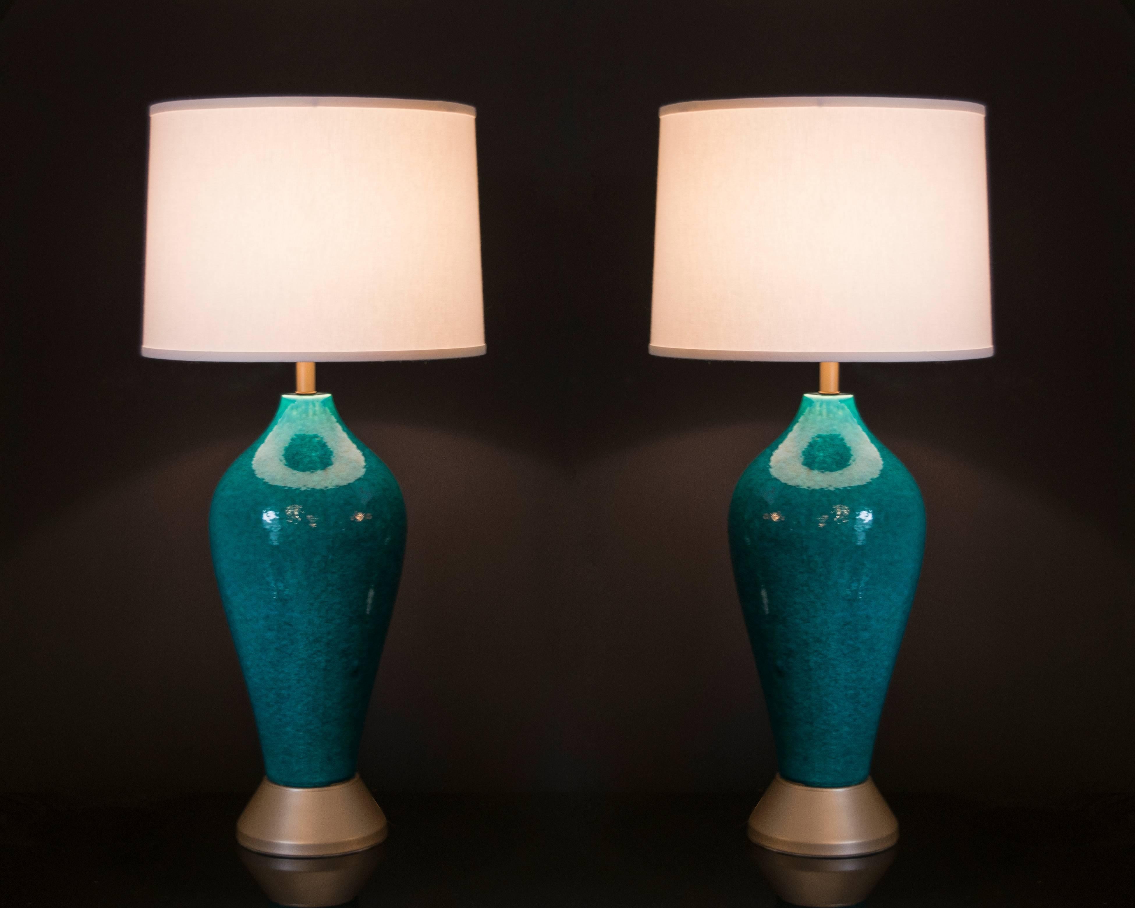 This pair of lamps has the most beautiful color of turquoise with a mottled glaze finish. The lamps are in excellent condition with the exception at the top of the lamps there are some glazing drips. These are not noticeable nor do they detract from