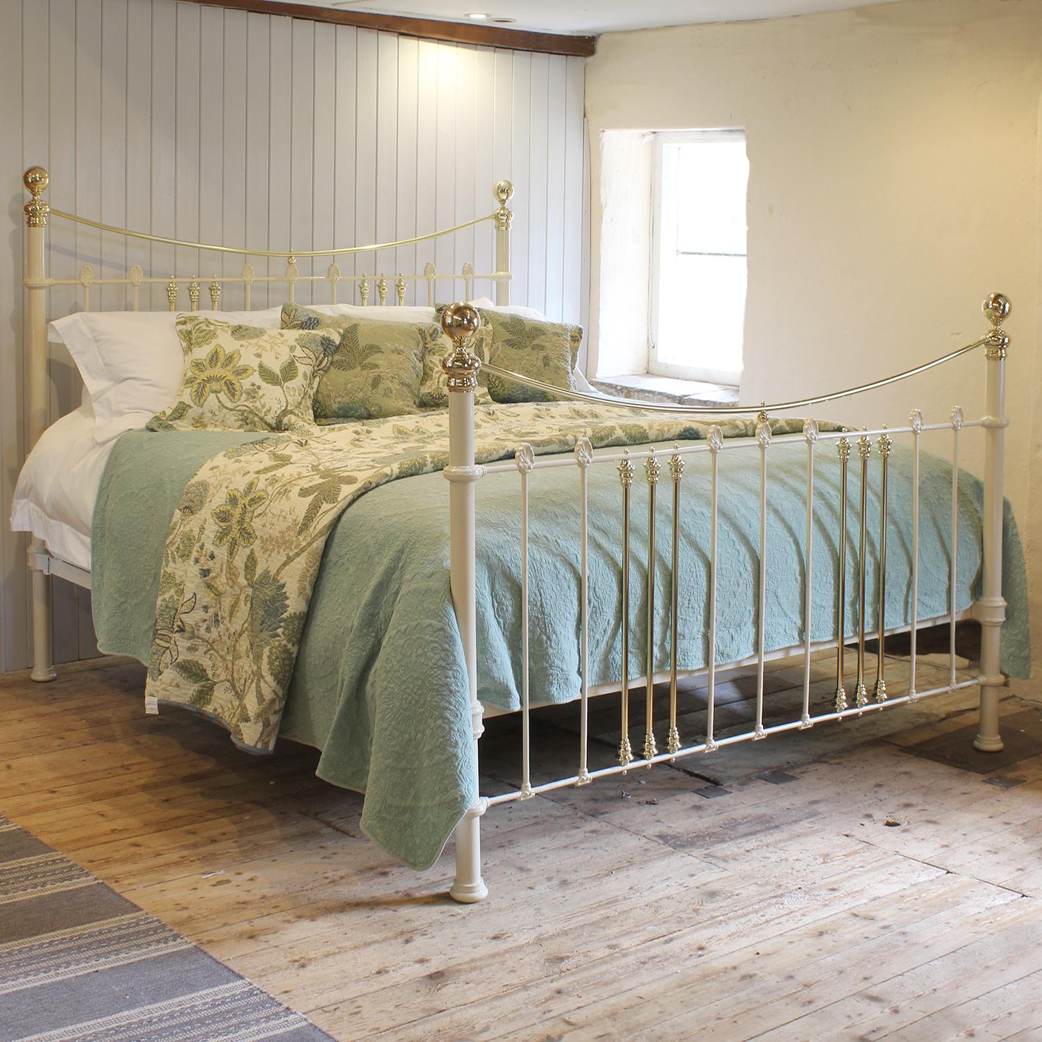 An attractive 6ft wide (72 inches) brass and iron antique bed finished in cream with brass curved top rail and decorative castings adapted and extended from an original Victorian frame, circa 1895.

This bed accepts a UK Super King or Californian