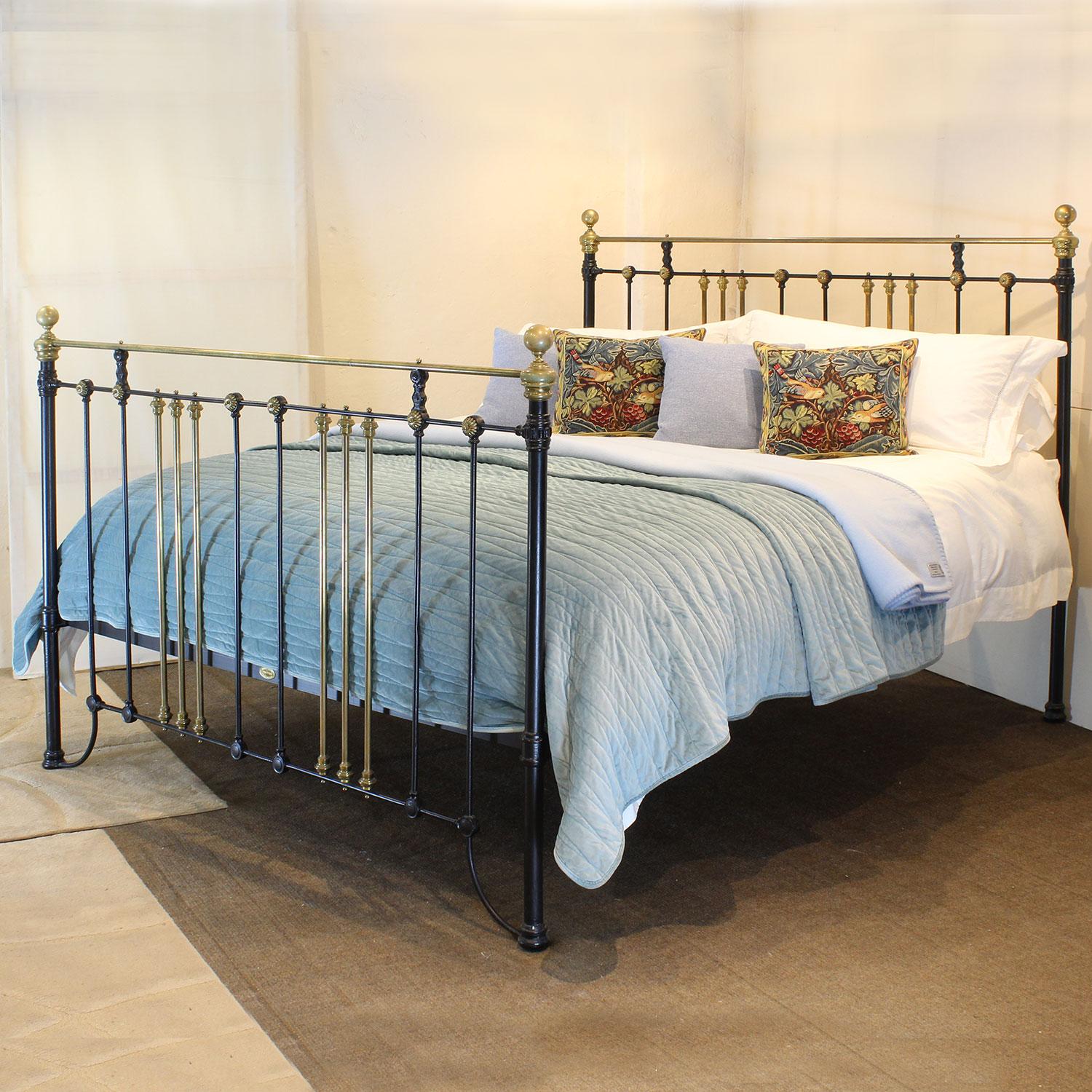 An attractive 6ft wide (72 inches) brass and iron bedstead finished in black with brass rosette decoration, adapted and extended from an original Victorian frame, circa 1895.

This bed accepts a UK Super King or Californian King 72 inch wide base