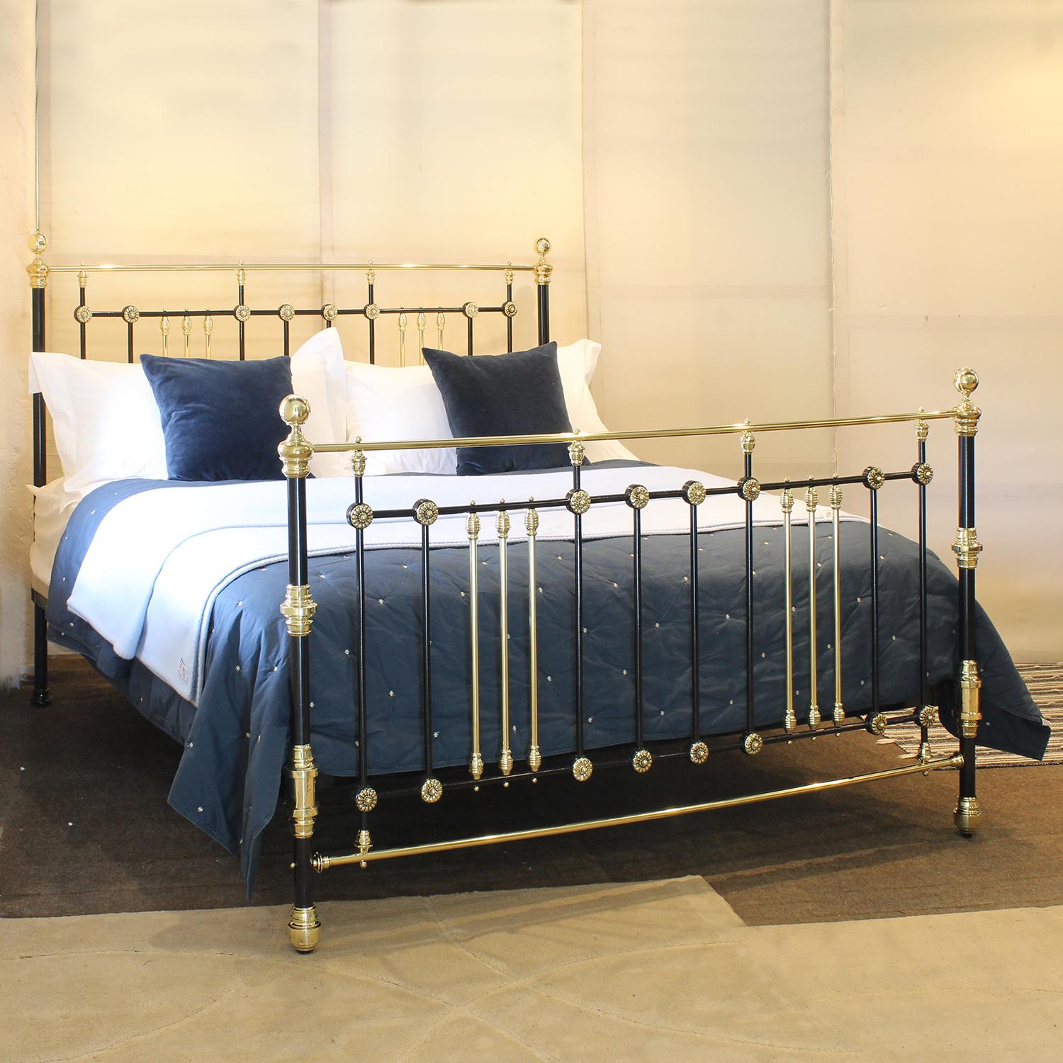 An attractive 6ft wide (72 inches) brass and iron bedstead finished in black with brass rosette decoration, adapted and extended from an original Victorian frame, circa 1895.

This bed accepts a UK Super King or Californian King 72 inch wide base