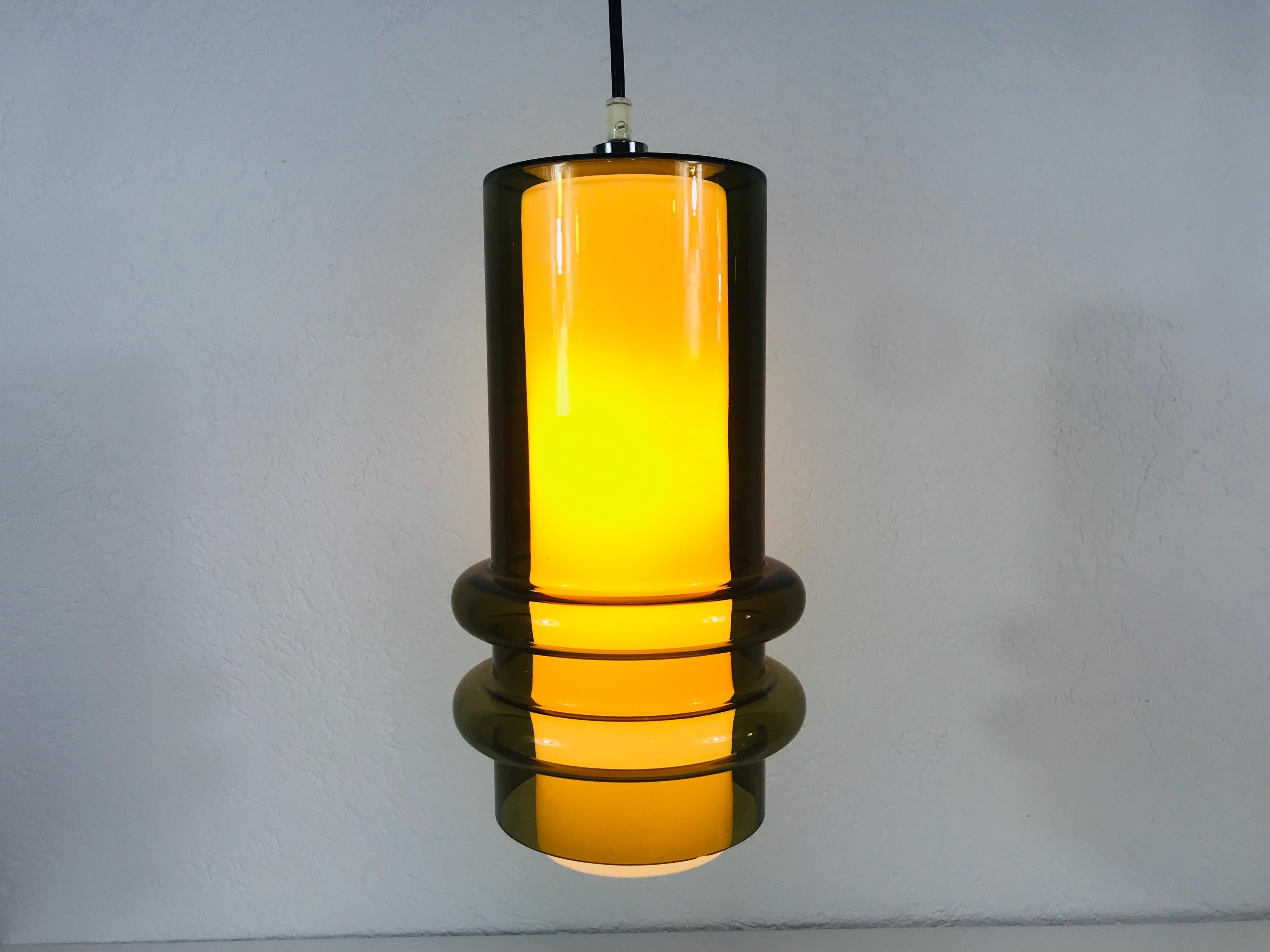 Very rare glass pendant lamp by Tapio Wirkkala. It has two glass shades, one white glass shade in the amber glass shade.

Height of shade: 37 cm 

Max Height: 100 cm 

The fixture requires one E27 light bulb.