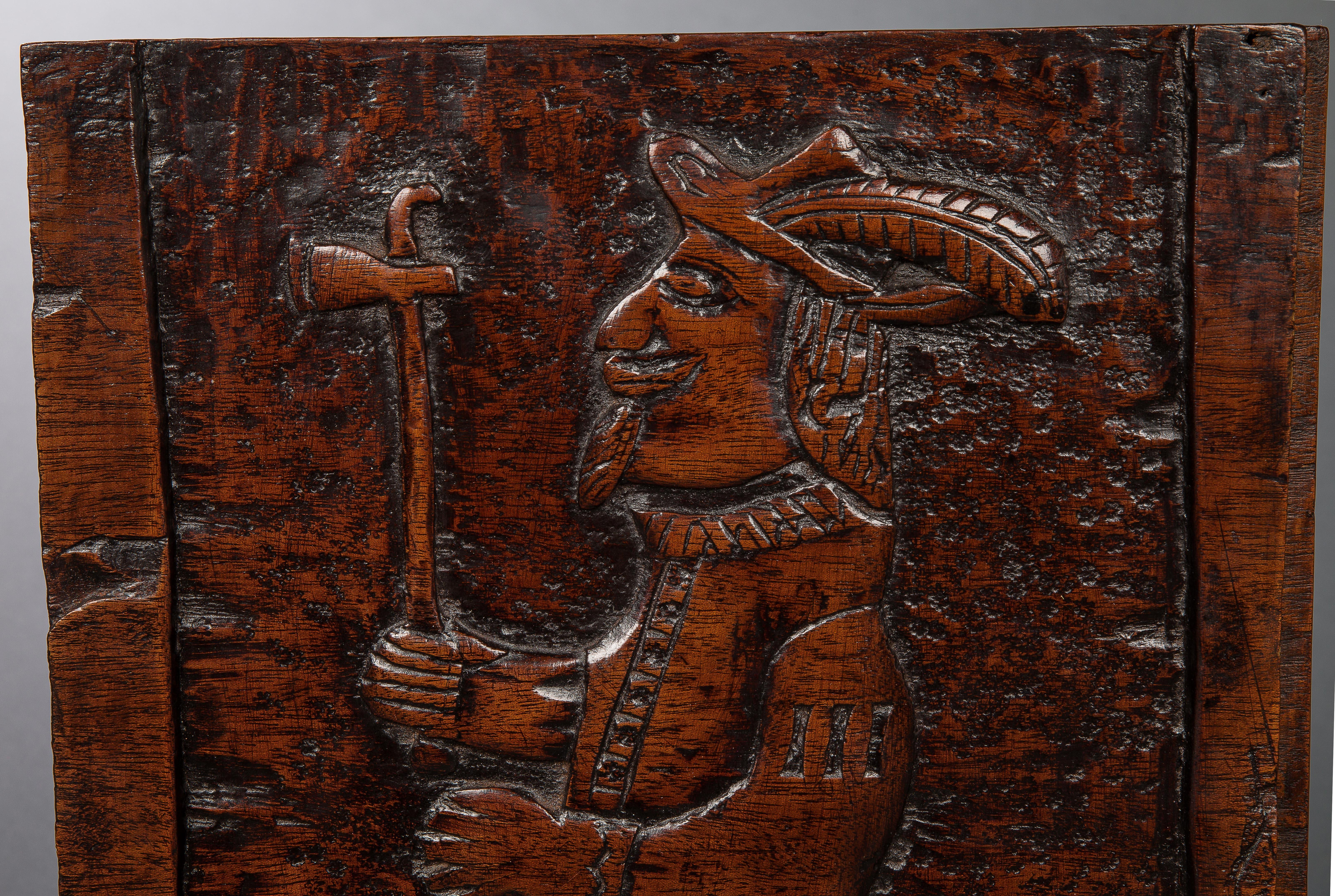 Possibly unique this thick mahogany panel depicts a European in late 16th or early 17th century costume with plumed hat brandishing a tomahawk on a background of punch work. The Algonquin Indians, pre-European colonization, developed the tomahawk, a