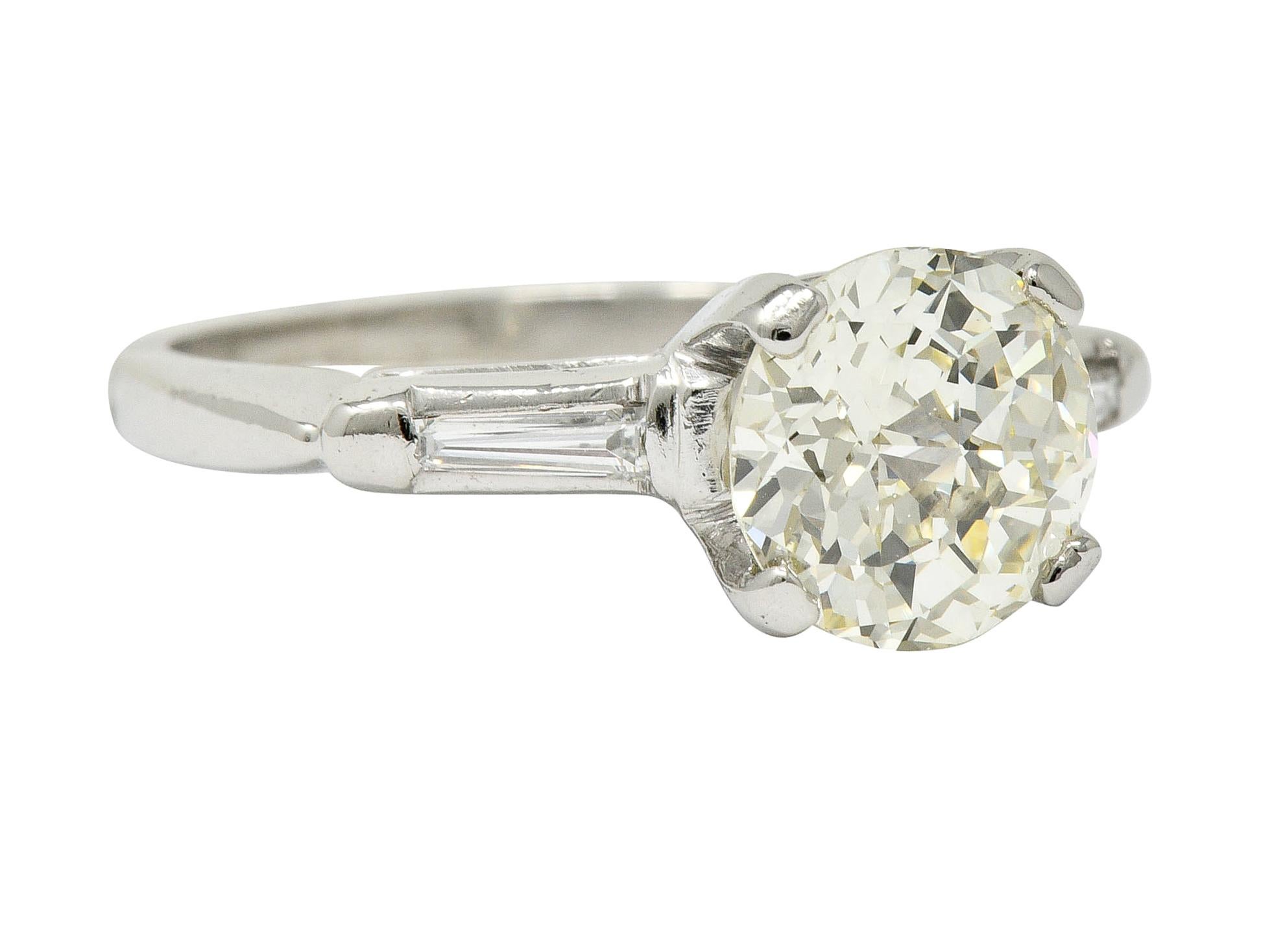 Centering a basket set jubilee cut round diamond weighing 1.72 carat; N color with VVS2 clarity

Flanked by two bar set tapered baguette cut diamonds weighing approximately 0.10 carat; eye-clean and white

Mounting is stamped for platinum, circa