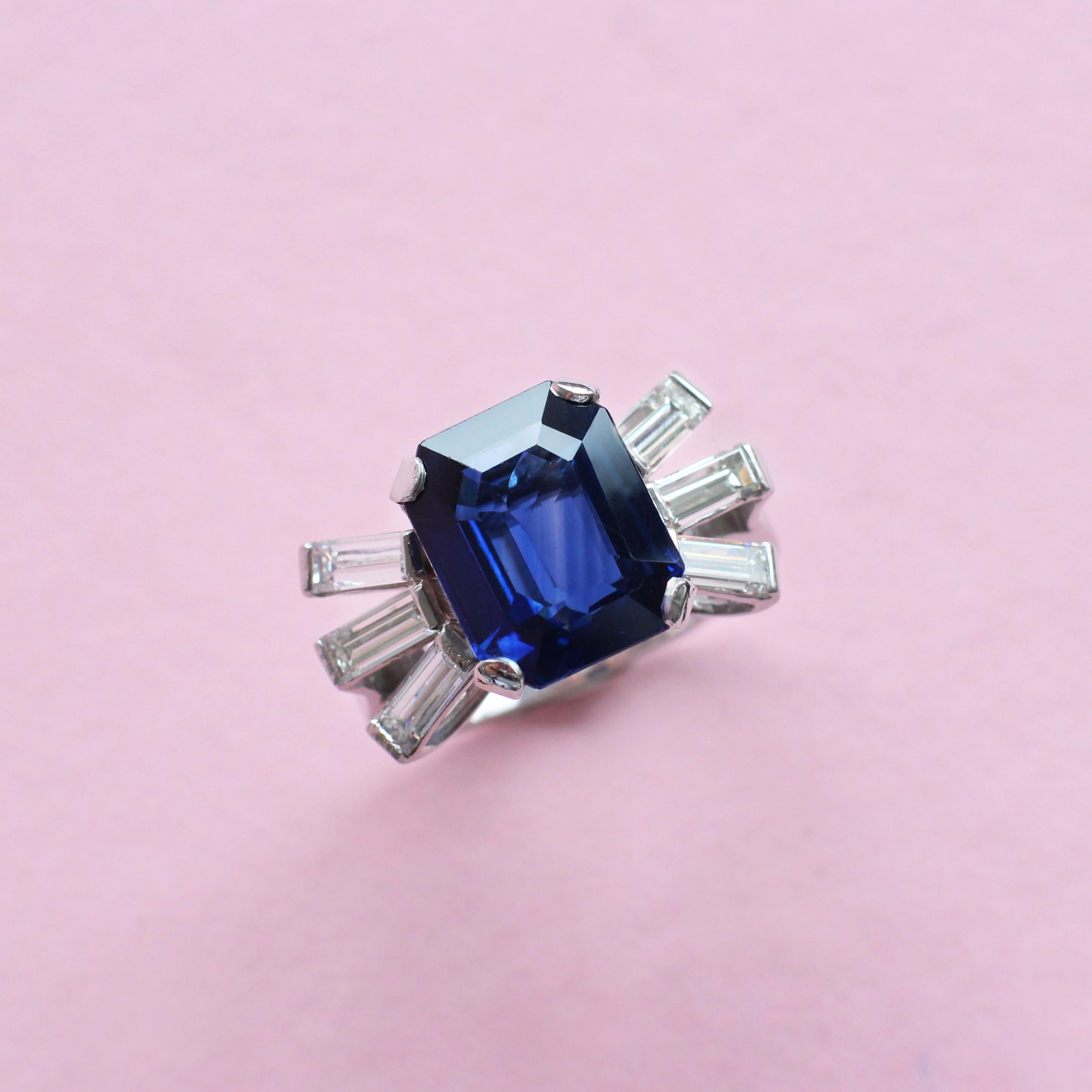 Feel bold and fearless with this powerful statement ring, hand-crafted in the Haruni workshop. Its centre stone is a beguiling five-carat, deep blue sapphire, featured in an octagon cut and positioned between six white baguette diamonds for a truly