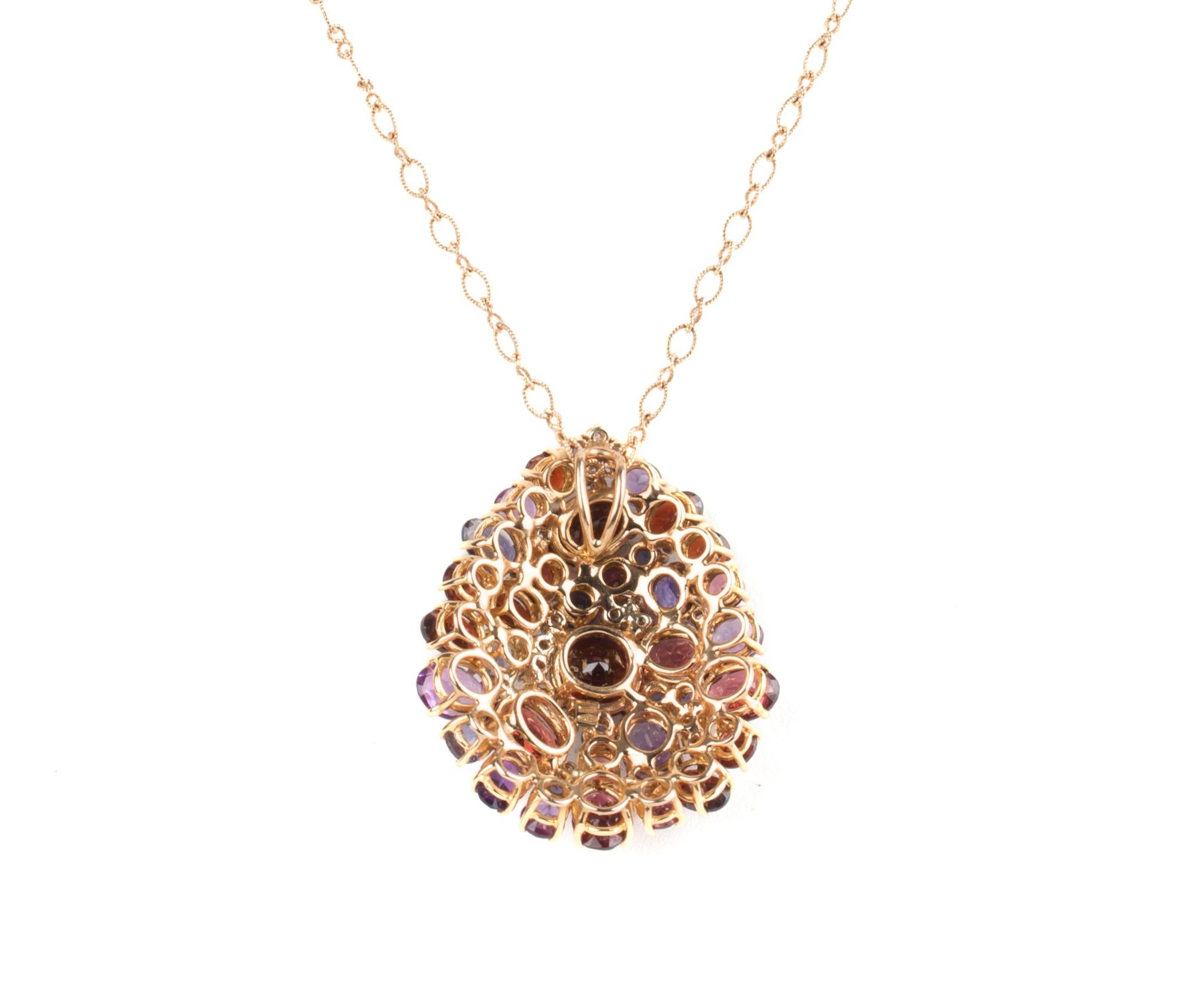 The pendant features a mixture of gemstones: Amethysts, Iolites, Garnets and Diamonds .
17 Carat Gemstones and 0.33 Carat of Diamonds set in 18 Karat Rose Gold.