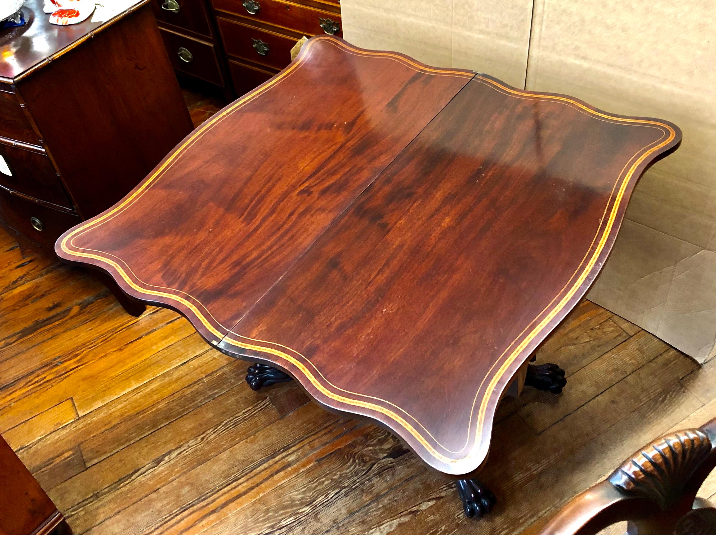 Possibly one of the finest late Federal or early Empire inlaid mahogany flap-top card or games tables; The table is serpentine in shape and attributed to having been made in a prominent unknown New York cabinetmaking shop, possibly influenced by the