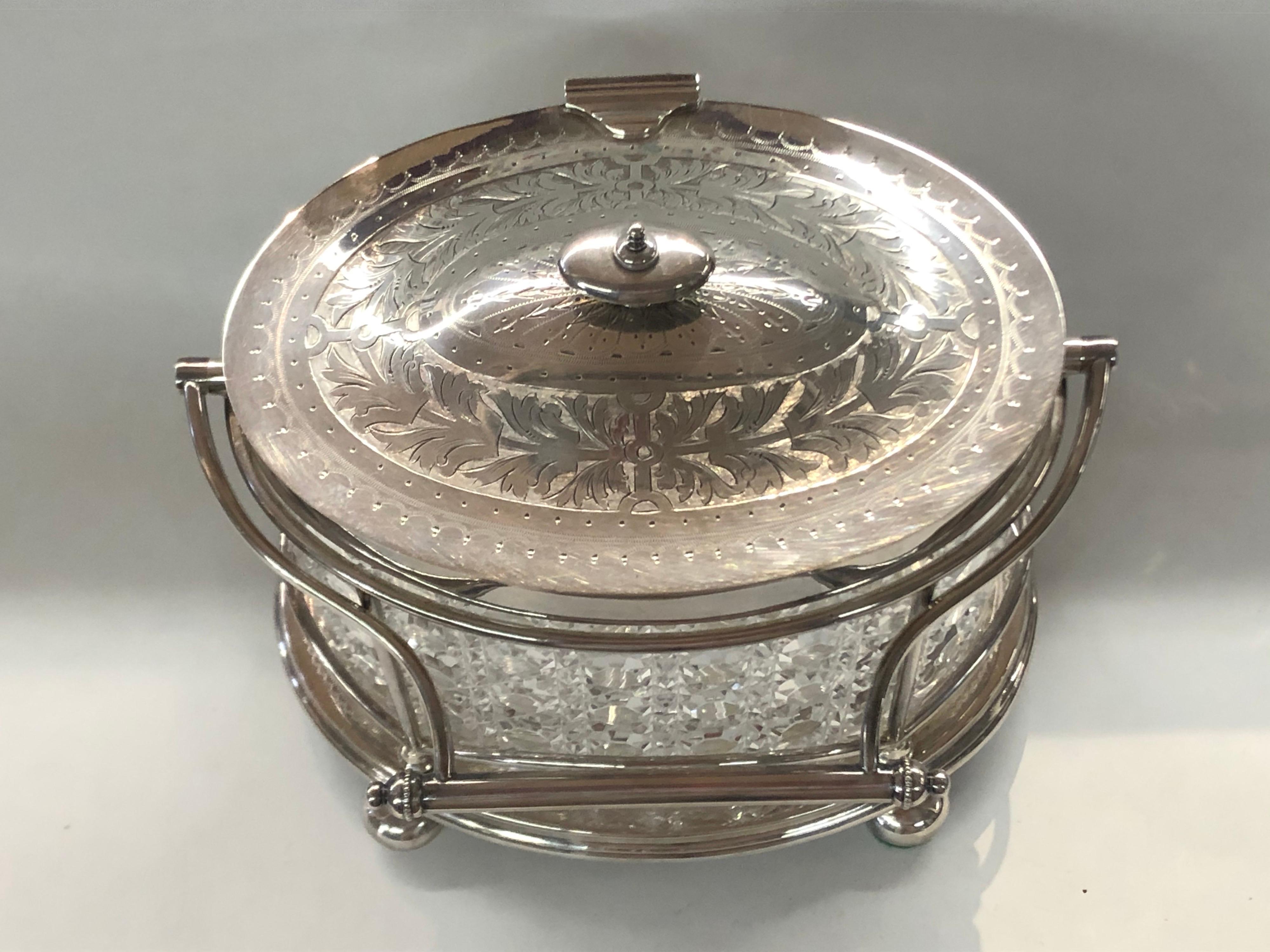 One of the finest hand engraved Antique English Sheffield Silver plate and hand cut crystal oval Biscuit Boxes with no plate loss or condition issues whatsoever. The exceptionally hand cut glass original oval liner is pristine and please note the