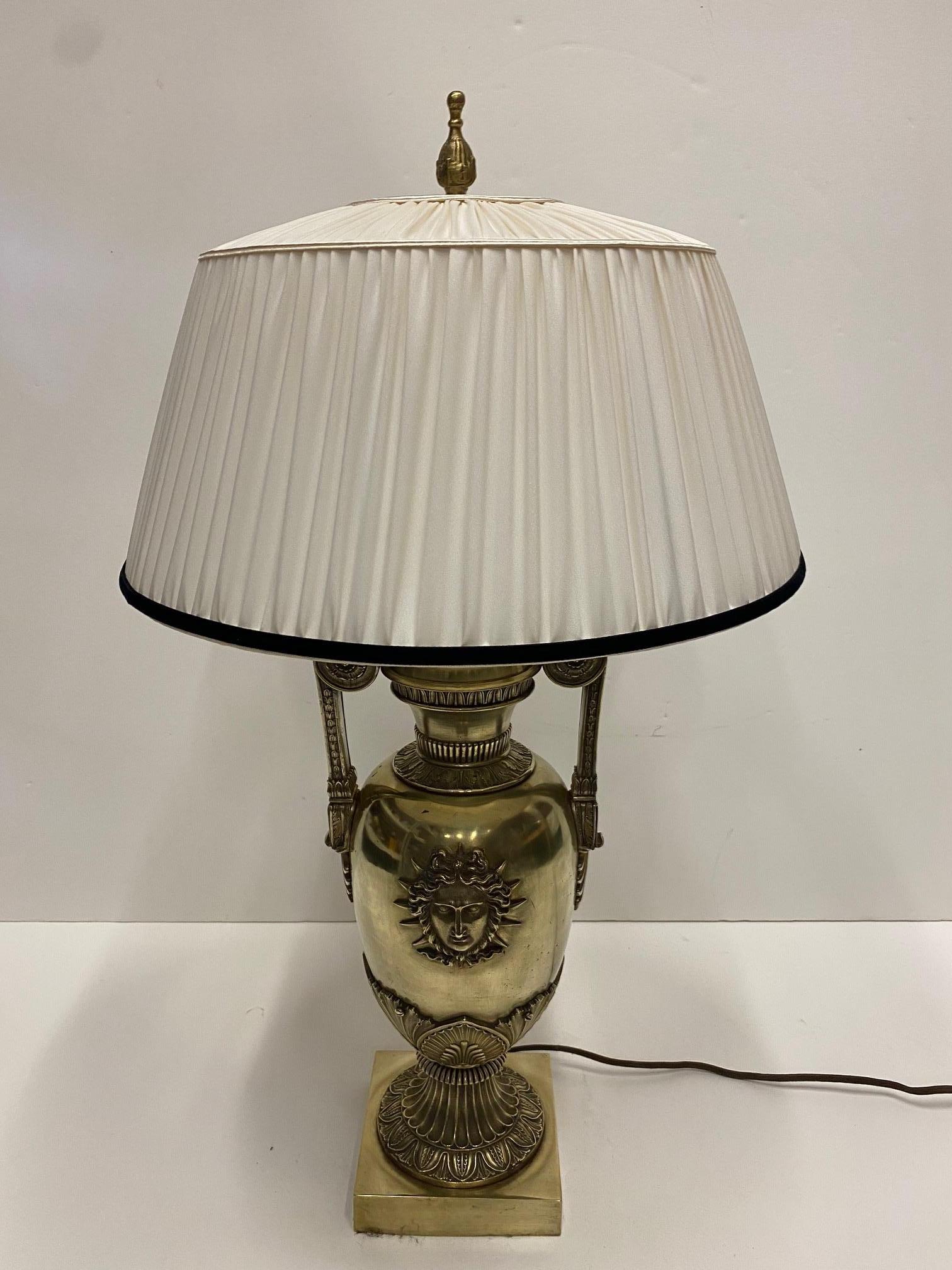 A particularly beautiful French cast bronze table lamp having central mythological face perhaps of a sun god, including custom silk shade and silk cord on wire.
Lamp itself measures: 27 H, 7 W, 7 D.