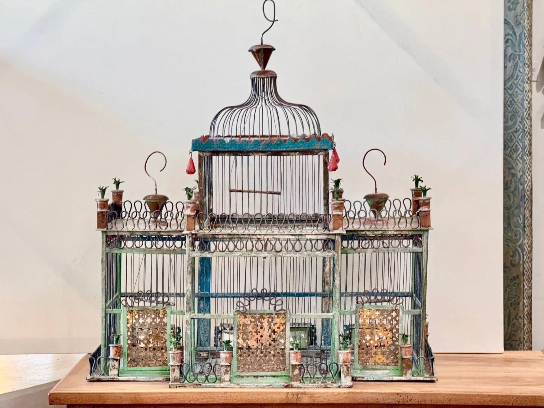 Architectural Birdcage with Painted Wirework and Tin panels.  A finely constructed architectural birdcage, likely French or Spanish, featuring arched domes, hand-painted wirework, pierced tin panels, and ornamental plantings. Late 19th to early 20th