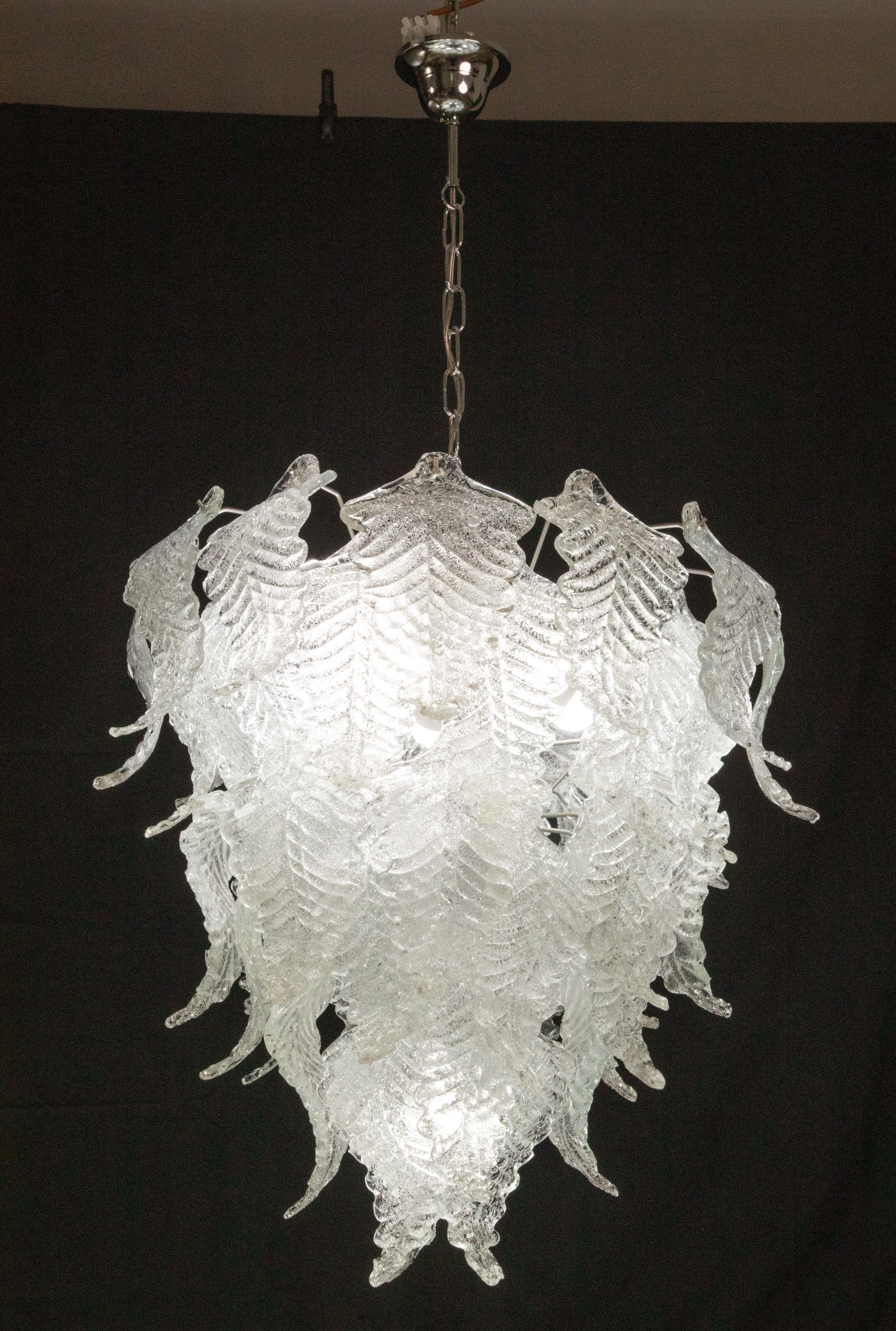 Murano glass chandelier suitable for decorating a large space.
The chandelier is made up of two rounds of glass which are articulated on 3 levels for a total of 48 glasses.
The luminaire measures 120 cm with the chain, 80 cm without the chain, on