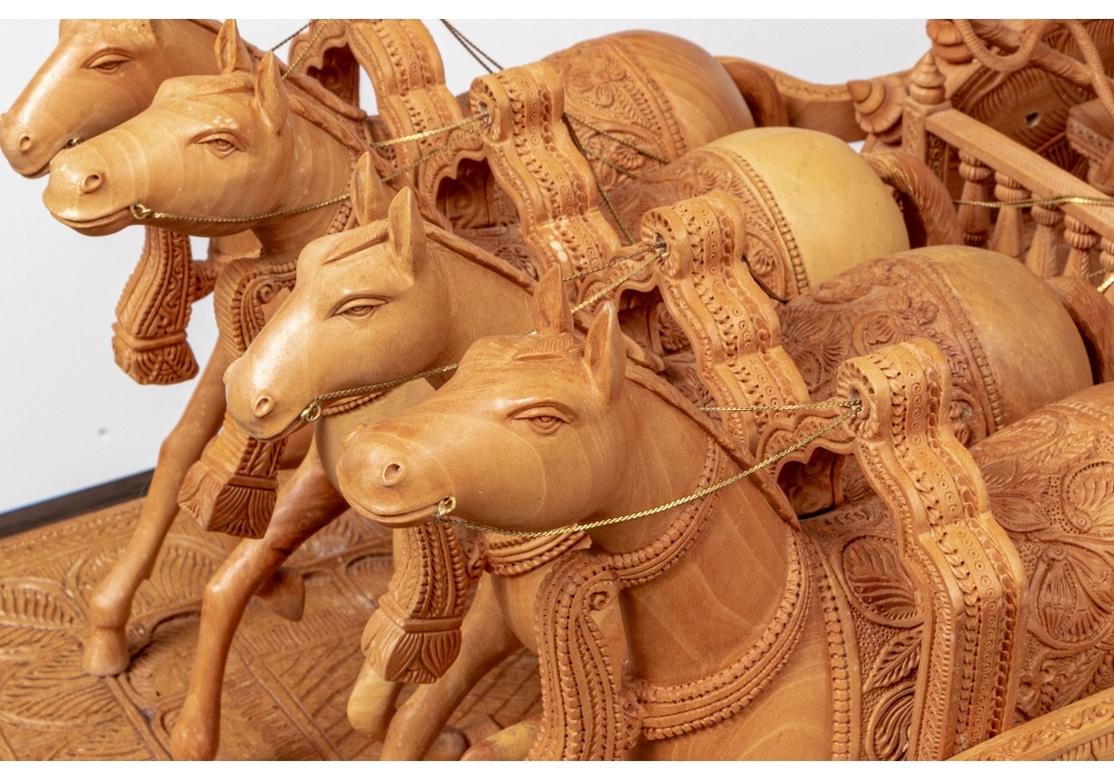 A large scale carved wood sculpture with extraordinary detail. The entire piece represents Krishna on his peace mission and preparation for war with the hostile Duryodhana. 
Later in triumph, here Krishna is the charioteer for the famed Archer