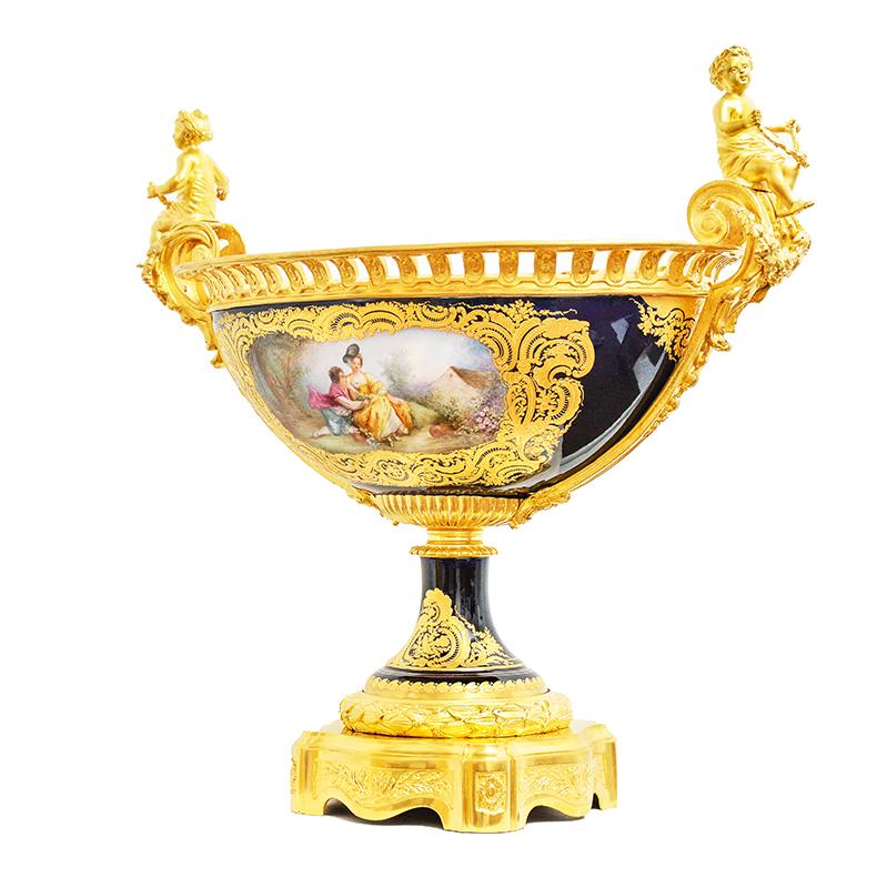Sèvres centerpiece in cobalt blue porcelain, mounted on gilt bronze (galvanic gilding). Assembled by hand and signed, with handles representing putti.