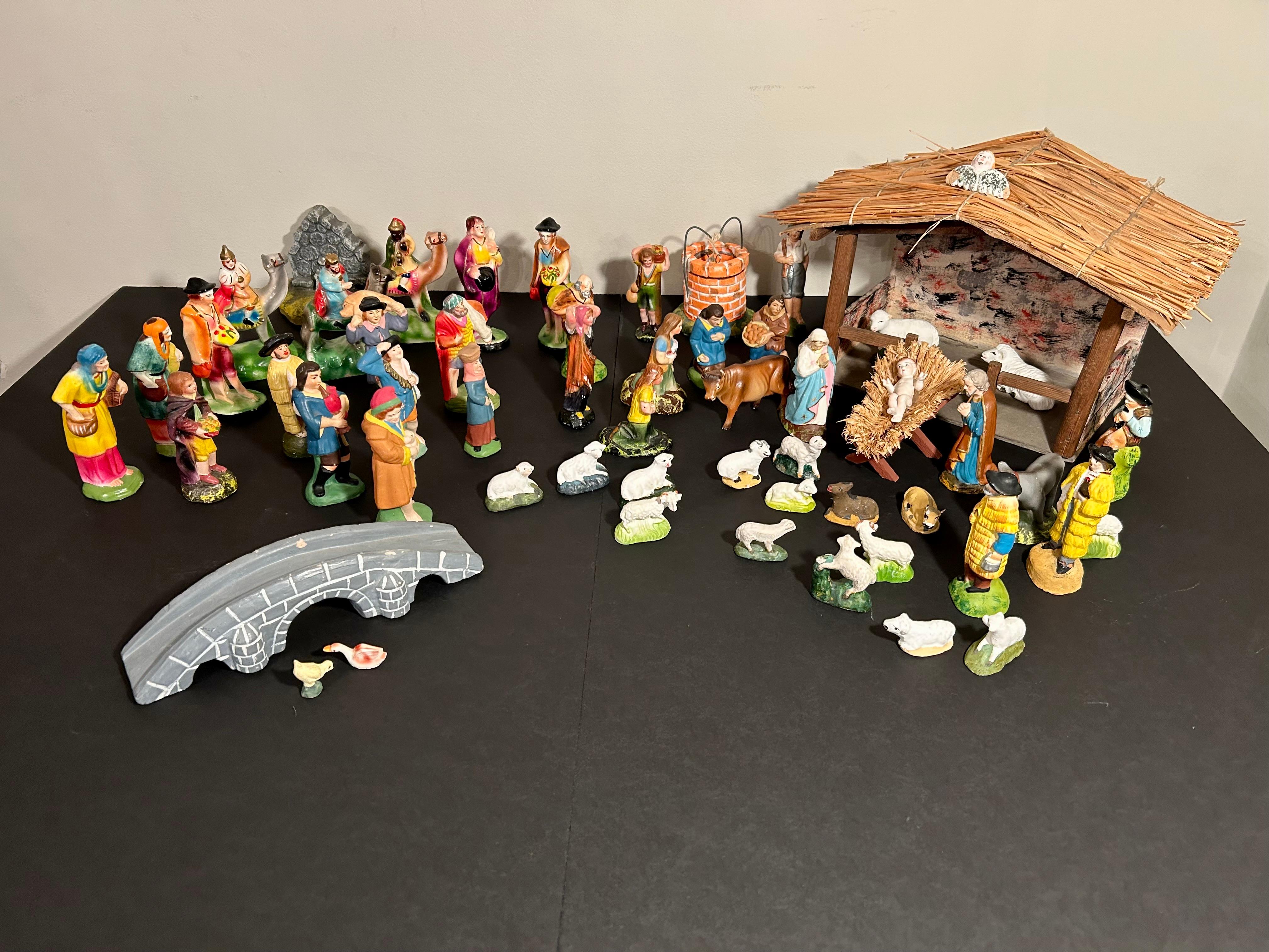 Incredible early 20th century nativity set from Portugal, most probably made in Caldas da Rainha, Portugal's renowned ceramic centre. 
This nativity set includes 56 figures: the holy family, a donkey, a cow, the three wise men, and an astounding