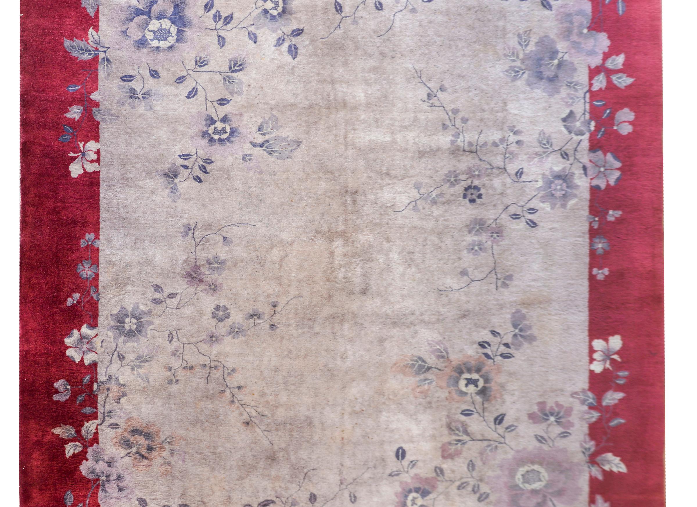 An exceptional early 20th century Chinese Art Deco rug with a unique and most beautiful grisaille pattern of myriad peony and scrolling vine clusters woven in varying shades of grays, and set against a gray field, and all surrounded by a rich