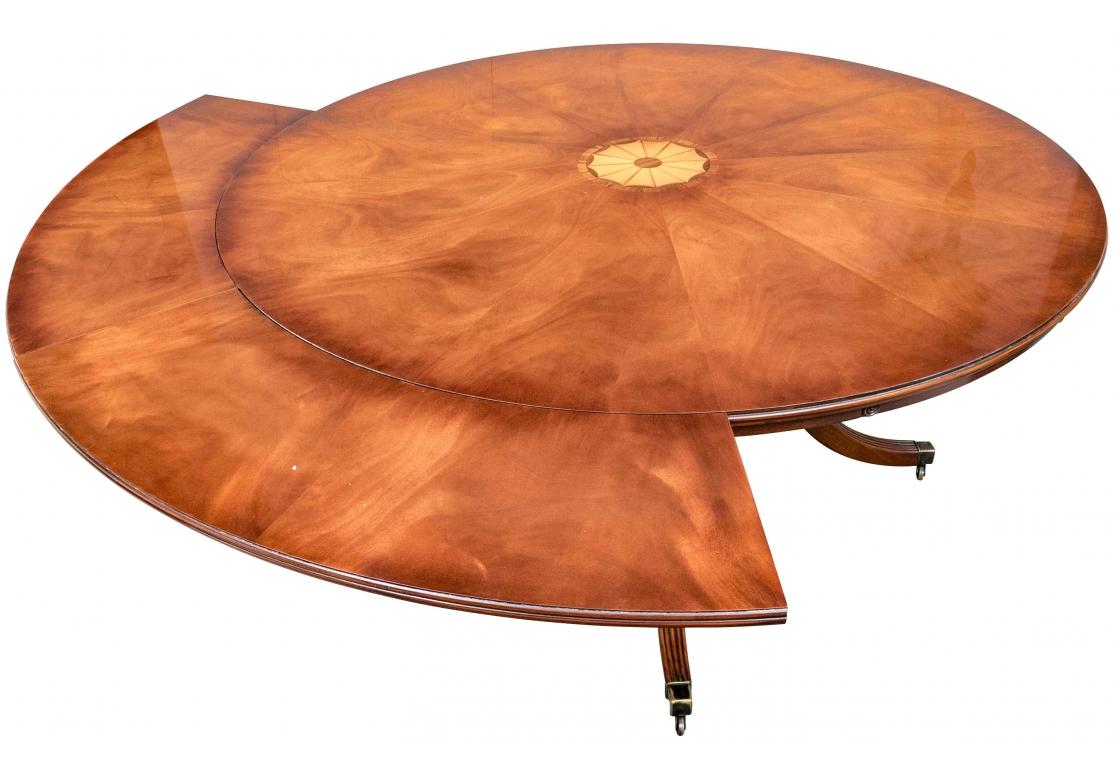   The spectacular Table design with side fitting surround leaves custom made from Mill House Antiques. The highly polished Table Top of the table with handsome chosen flame Mahogany Pie Wedge sections with a central inlaid circular Geometric design
