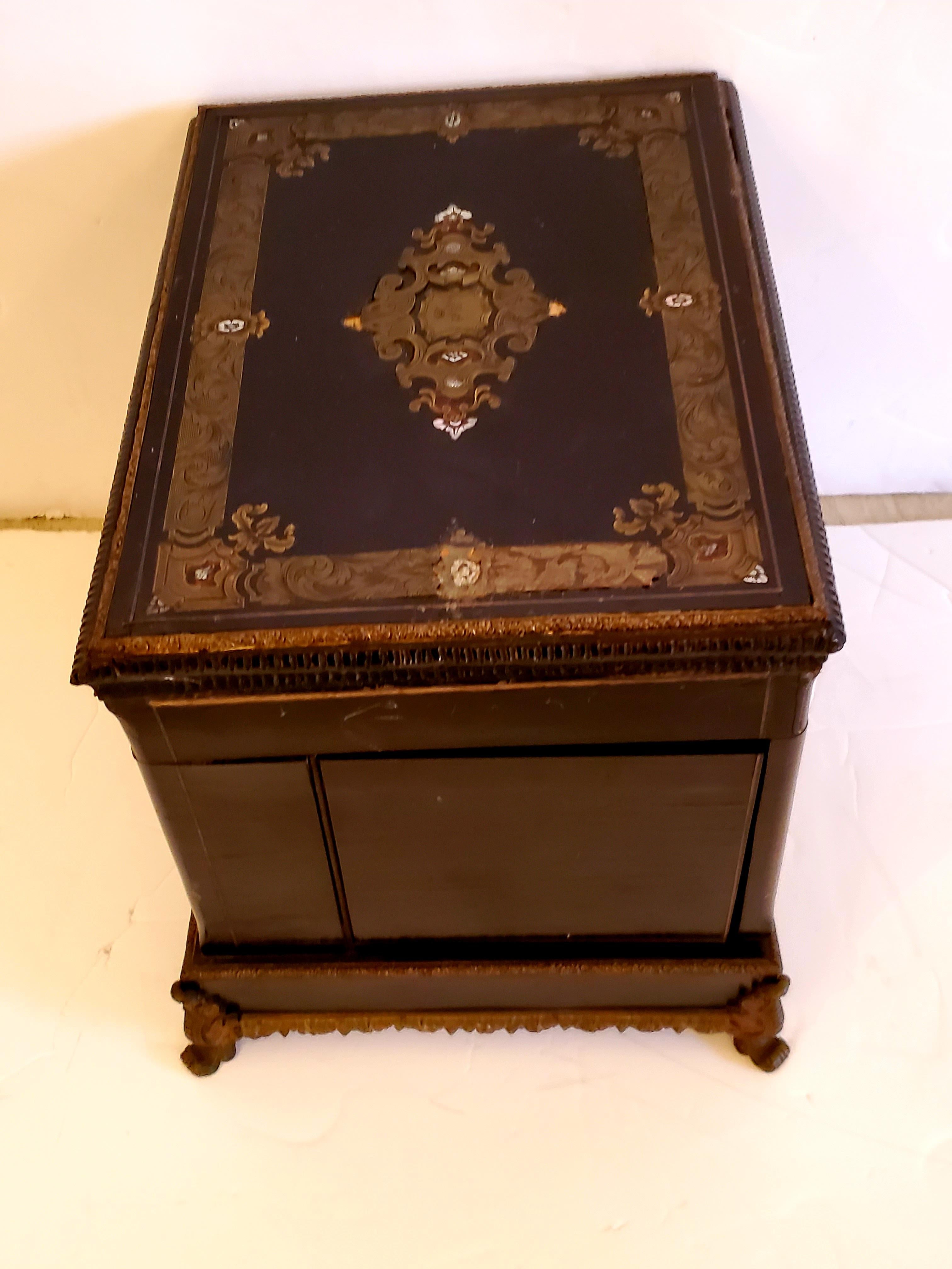 Exceptional painted jewelry box having ornate decoration and ormolu base. Interior has lined compartments.