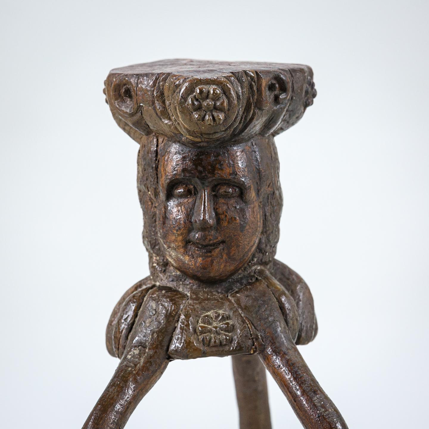 Impressive, small early 19th Century anthropomorphic cutting block believed to be a lacemakers station highly unusual rare carved head as the main body of the block with three sculptural legs. Crusty historical treacle painted finish. France Circa
