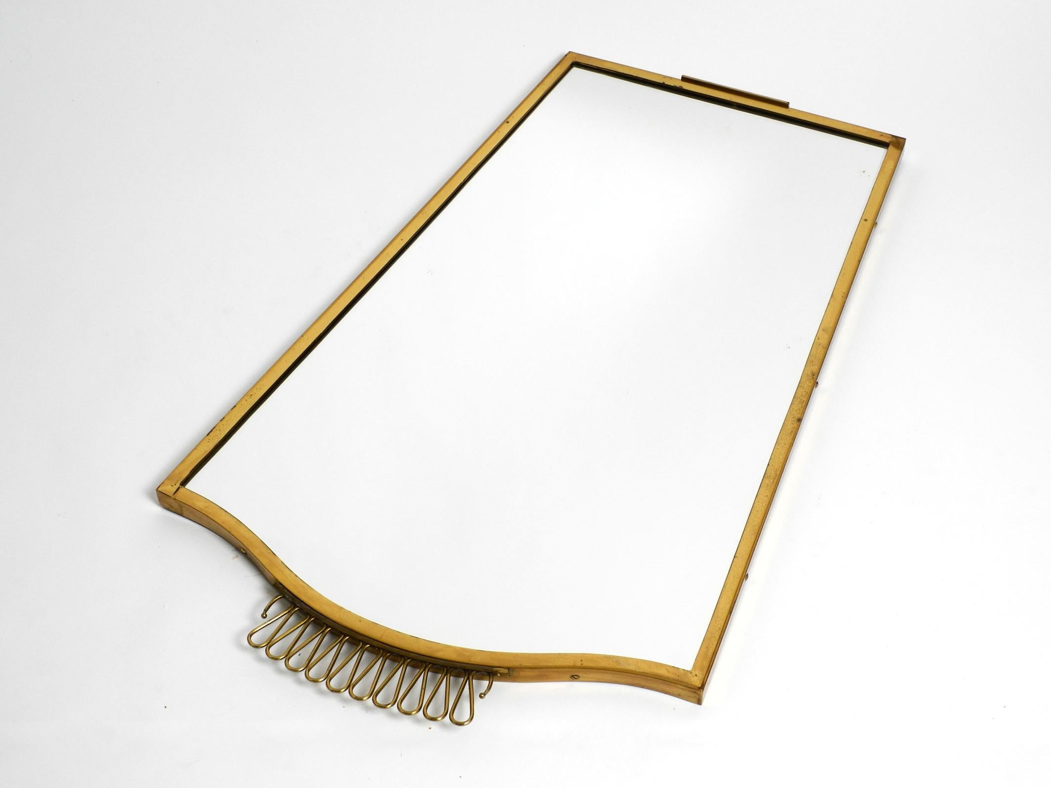 Extraordinary, elegant, large, heavy, Mid Century brass wall mirror In Good Condition For Sale In München, DE