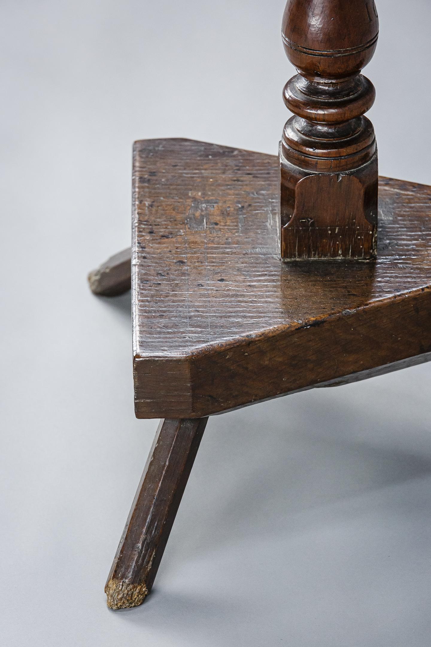 Extraordinary oak 17th century pedestal table. Wonderful form, rectangular boarded top, on a crude birdcage support fitted to a baluster stem which is pegged through a thick slab block that stands on three short chamfered legs. The Stem is is carved
