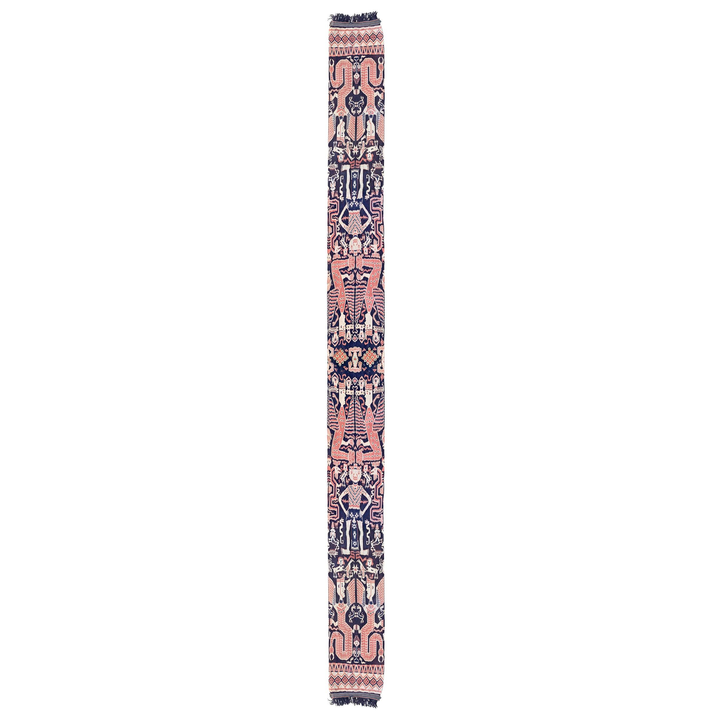 An extraordinary 20th century Indonesian hand-loomed ikat textile from the island of Sumba and depicting many lions, birds, serpents, and other mythological winged figures woven in beautiful vegetable dyed cotton. Textiles like these were