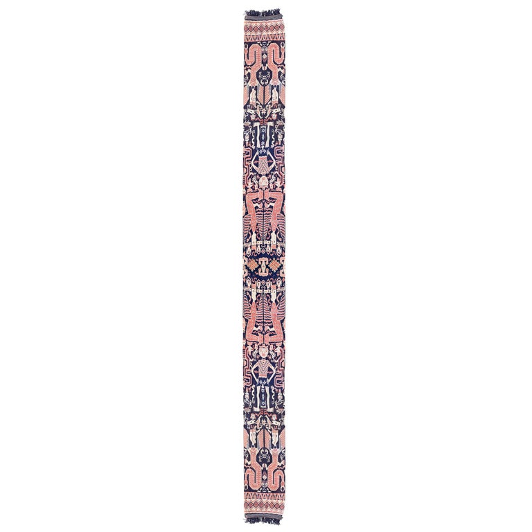 An extraordinary 20th century Indonesian hand-loomed ikat textile from the island of Sumba and depicting many lions, birds, serpents, and other mythological winged figures woven in beautiful vegetable dyed cotton. Textiles like these were
