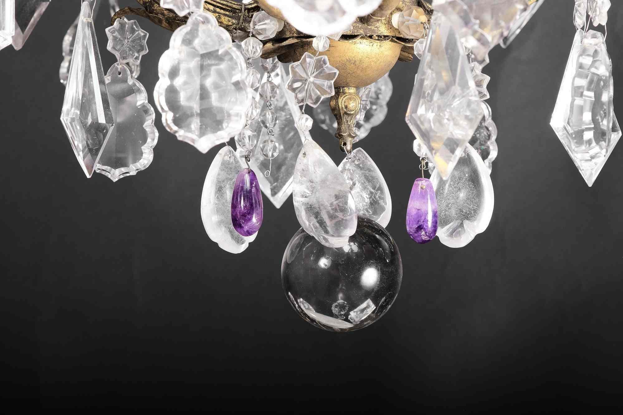 Very finely worked, patinated and gilded iron chandelier, with twelve lights. Magnificent wall hanging in rock crystal and amethyst of excellent quality. The large central sphere at the bottom and many large crystals are of an almost transparent