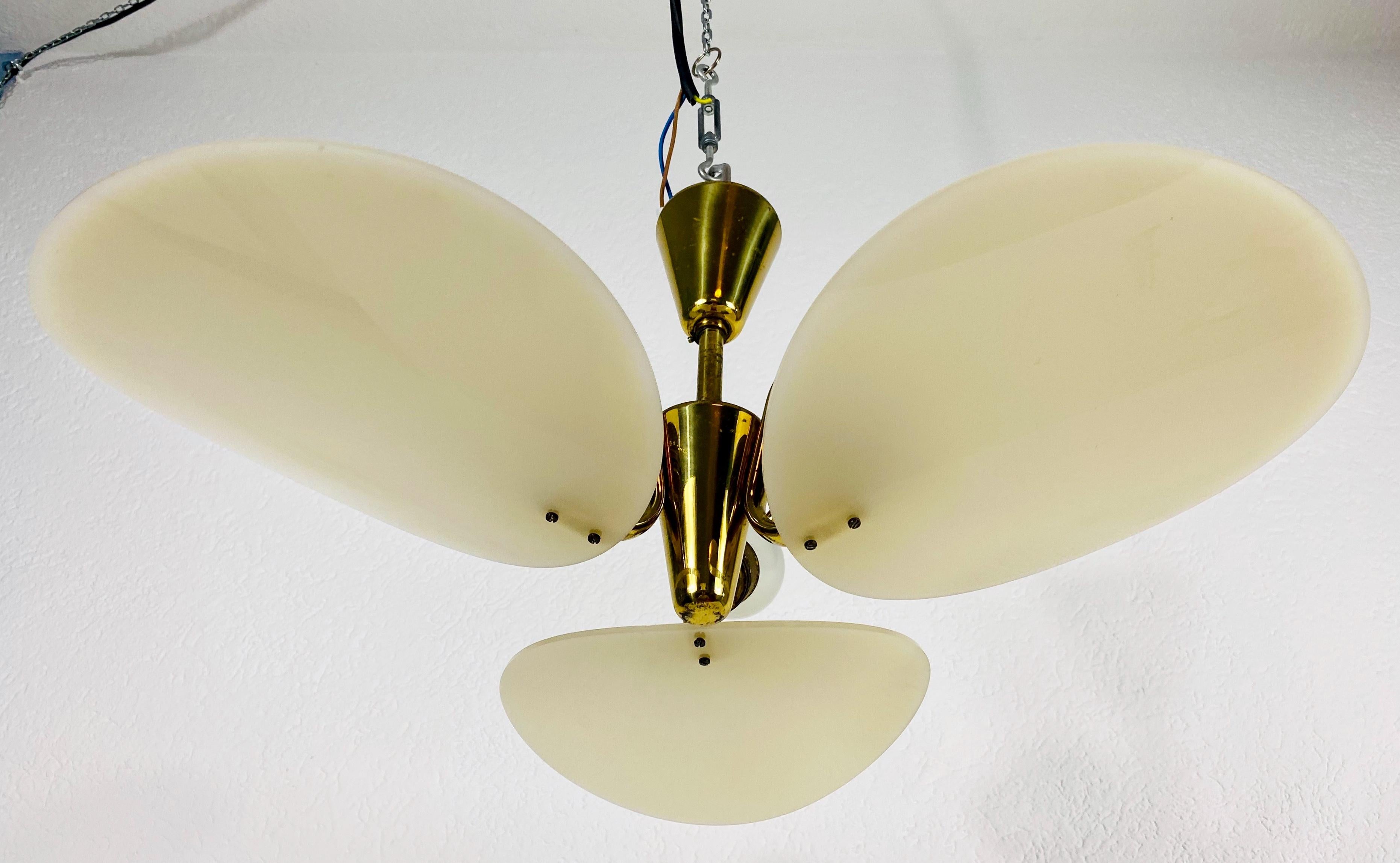 A very rare chandelier made in Italy in the 1950s in the style Stilnovo. It is fascinating with its 3 brass arms, each of it with an acrylic glass shade. The arms have a beige color.

Very good vintage condition.

The light requires 3 E14 light