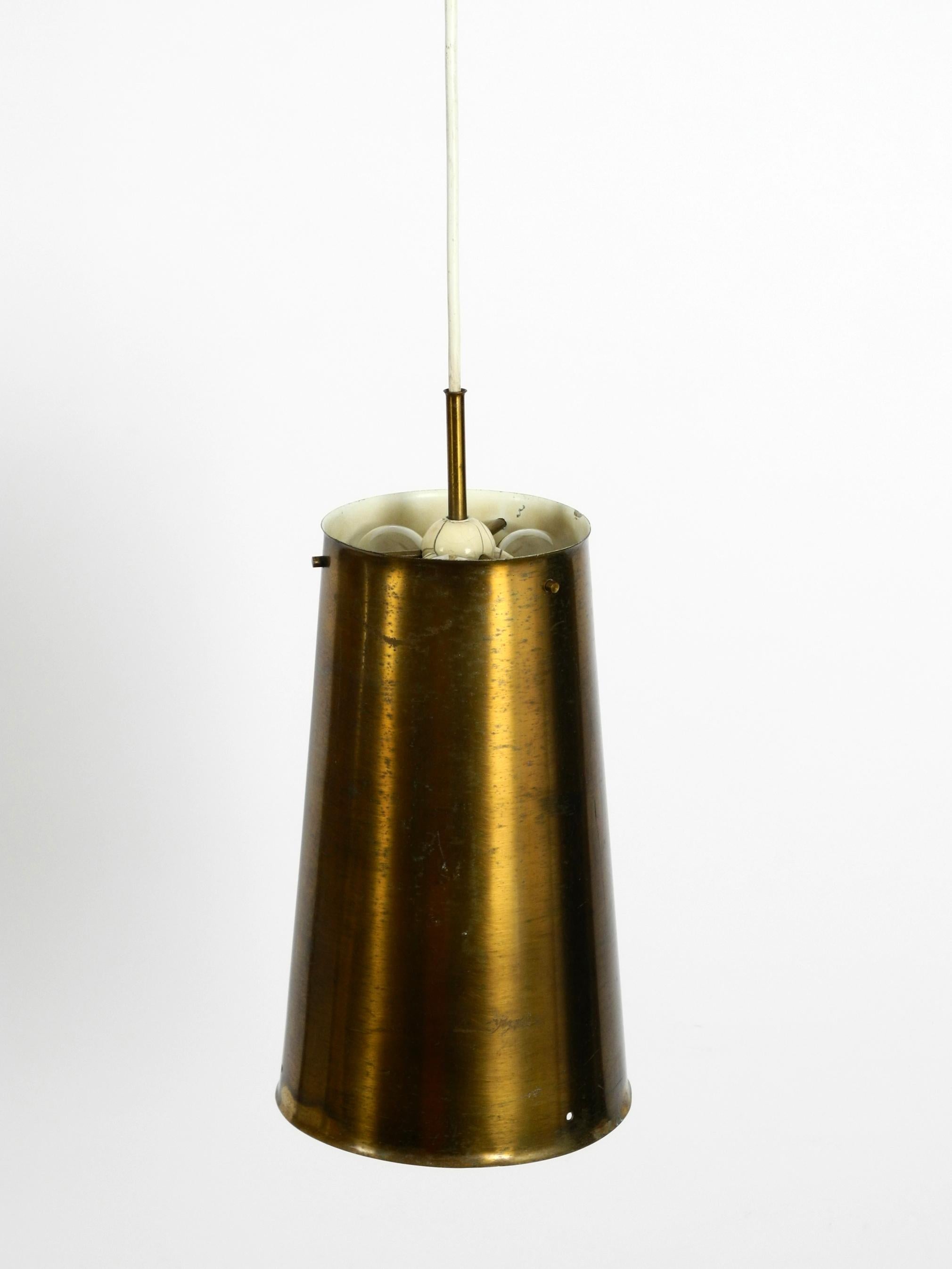 Very rare large Mid-Century Modern pendant lamp, shade is made of copper.
Manufactured By Bochumer Lampenfabrik 1950. Made in Germany.
It has one E27 socket inside the lampshade and three E14 sockets above.
Exceptional design in original