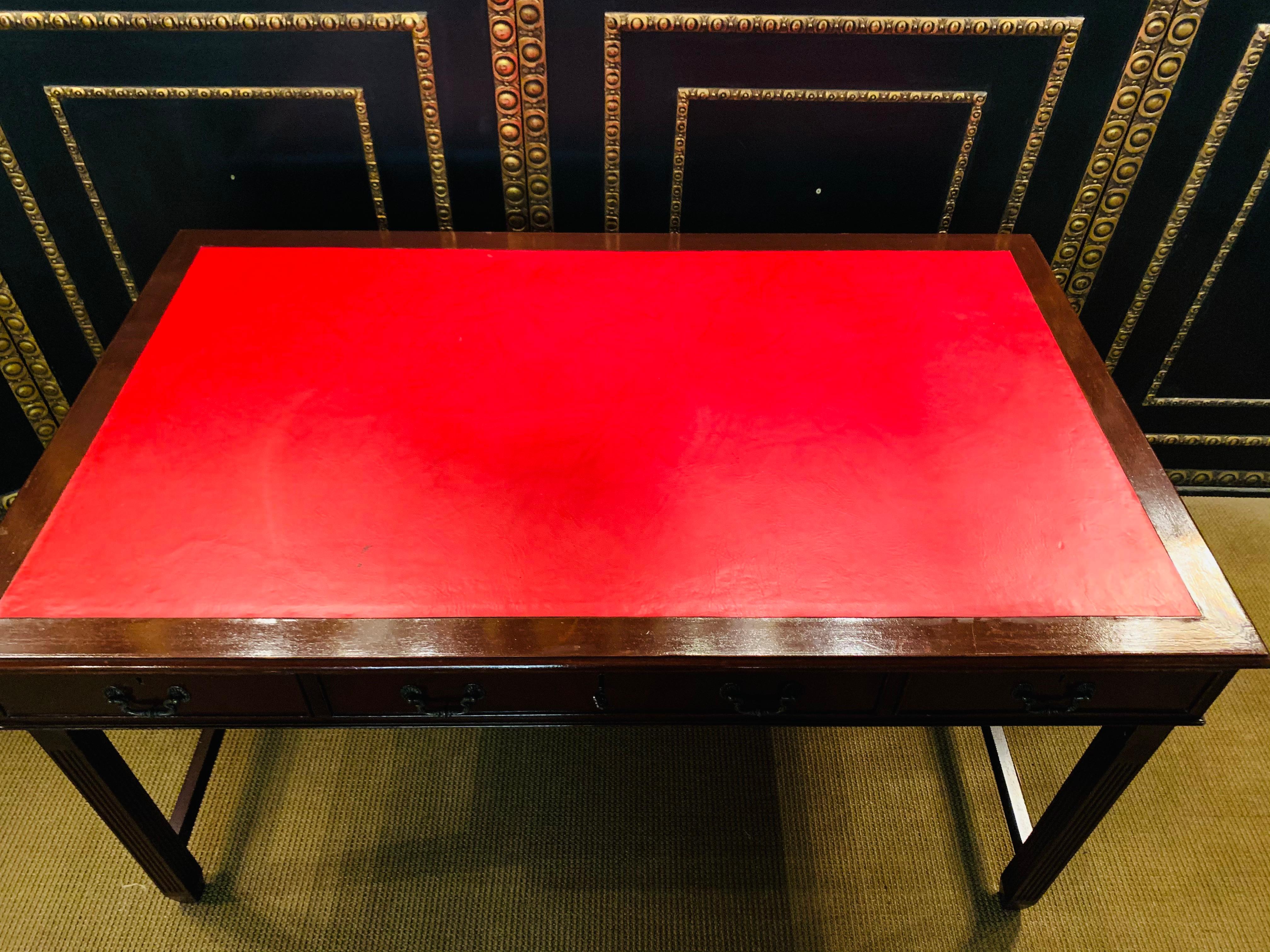 Beautiful extraordinary English desk with 3 drawers and red leather top. The plate can still be removed, but can be fixed if desired.