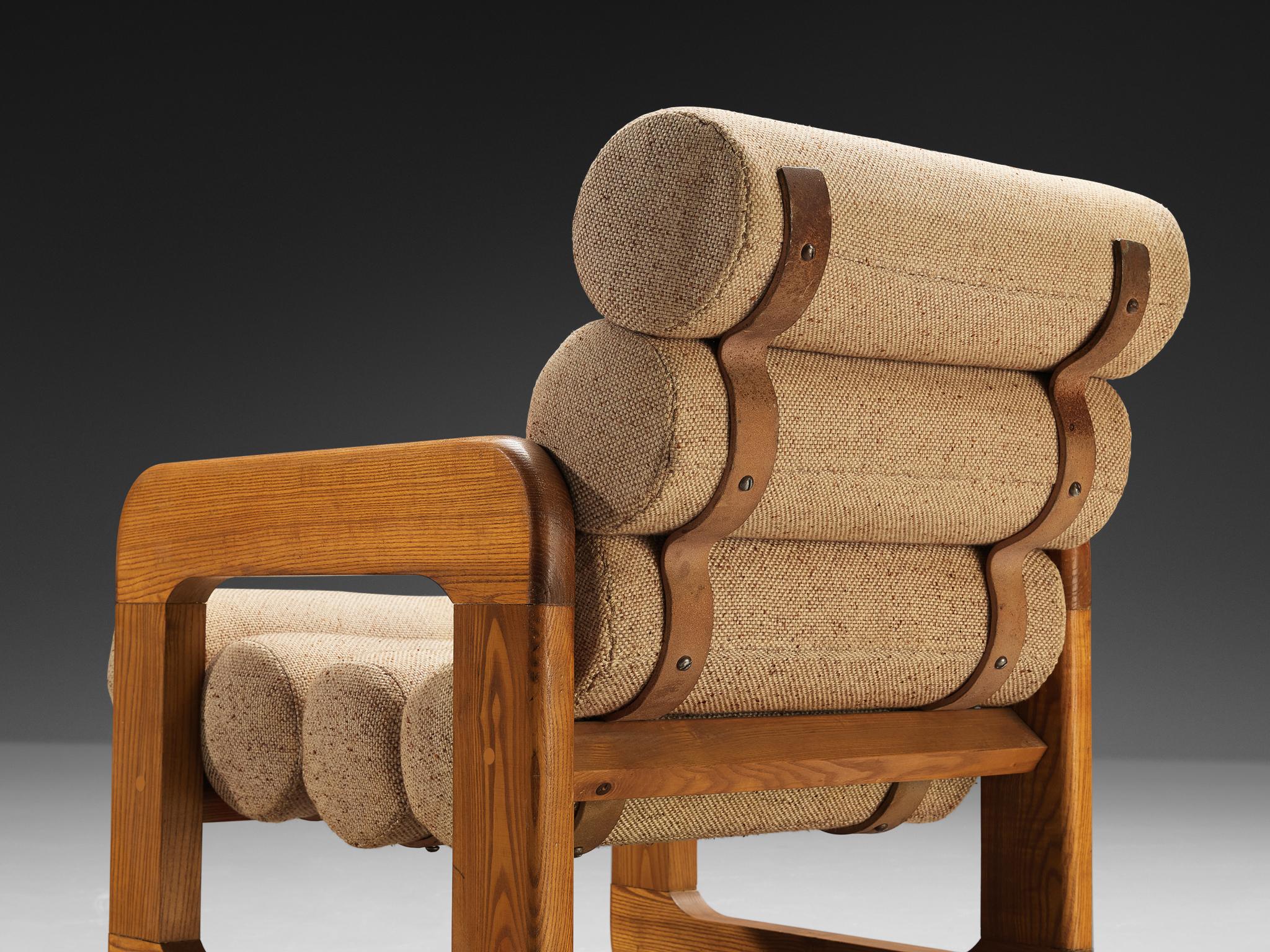 Sessel, Esche, Stoff, Eisen, Europa, 1970er Jahre.

Unkonventioneller Loungesessel, der sich durch ein außergewöhnliches Design auszeichnet. Die Sitzfläche besteht aus mehreren röhrenförmigen Kissen, die miteinander verbunden sind und eine