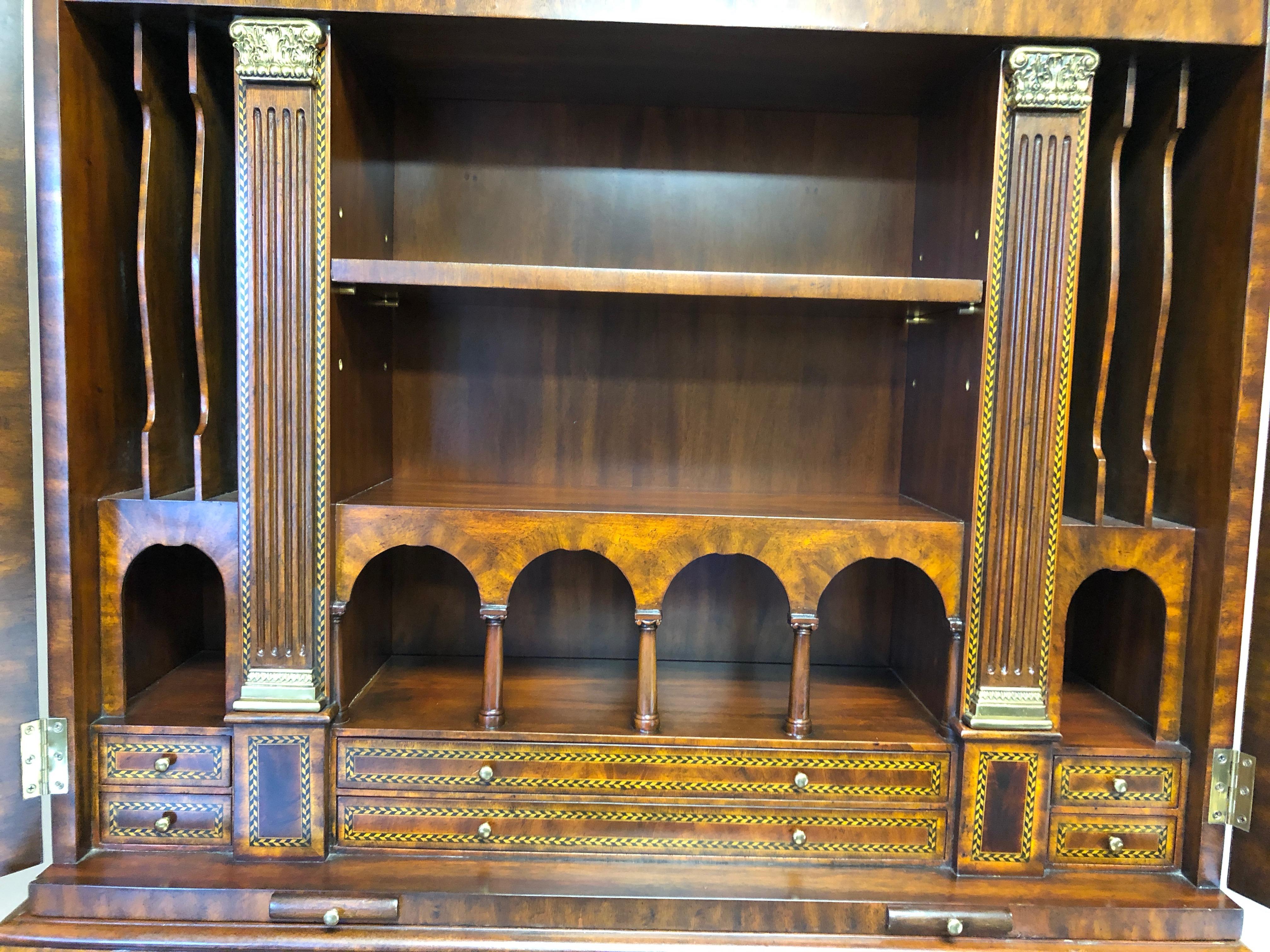 A superior impressively intricate secretary having amazing details such as satinwood and ebony inlay, leather embossed desk surface, a pair of slide out candle holders, gorgeous neoclassical decorations, tons of cubbies and a tudor or gothic style