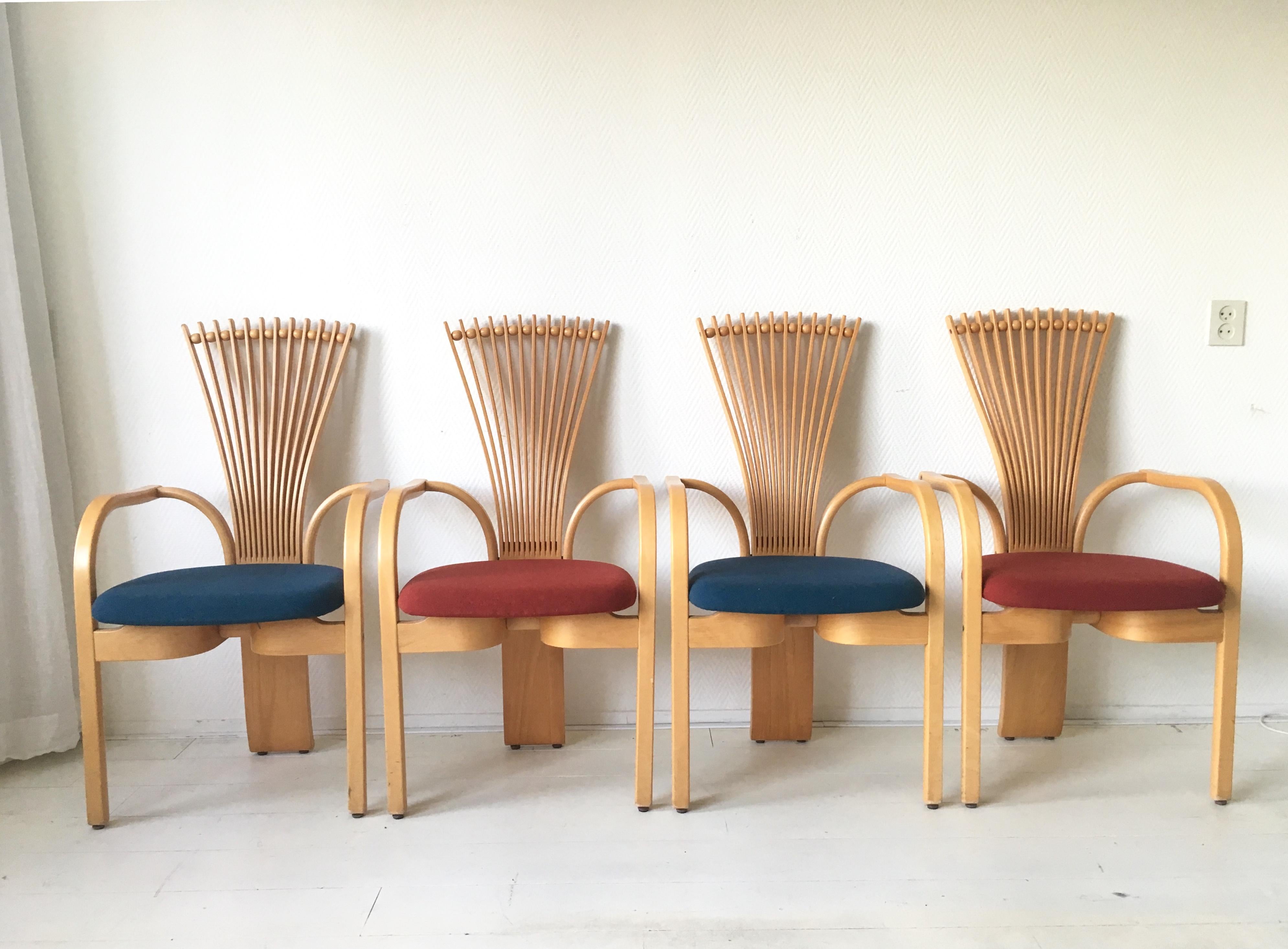 These sculptural Norwegian high back dining chairs were designed by Torstein Niksen for Westnofa. This Fan, or Totem chairs feature a massive Oak base with Blue and Red wool upholstery. If desired, they can easily be reupholstered with another