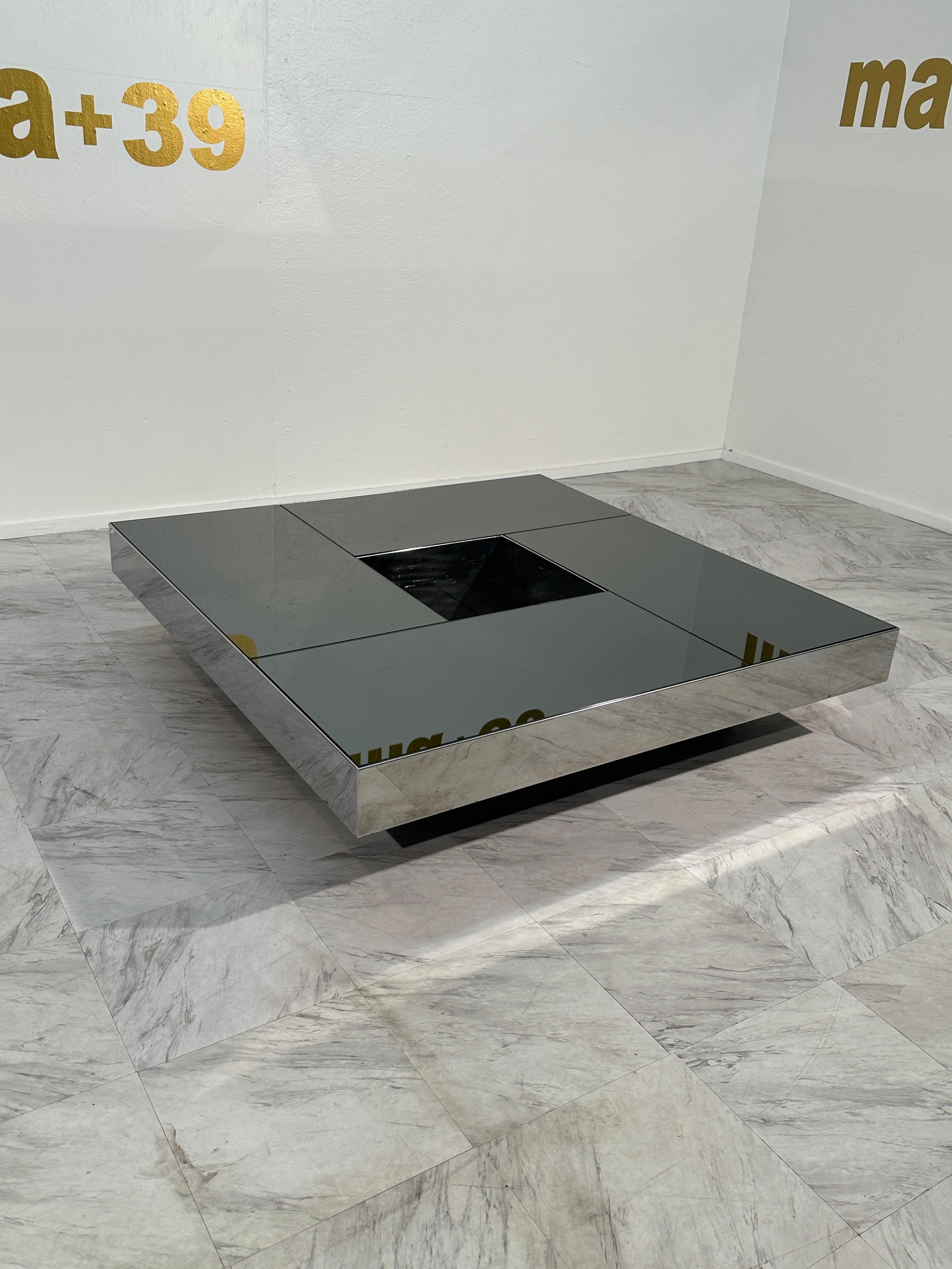 Experience the allure of Italian mid-century design with this Extraordinary Coffee Table by Willy Rizzo, crafted in the 1970s. The table's distinctiveness lies in its mirrored fume glass surface, exuding sophistication and timeless elegance. Adding
